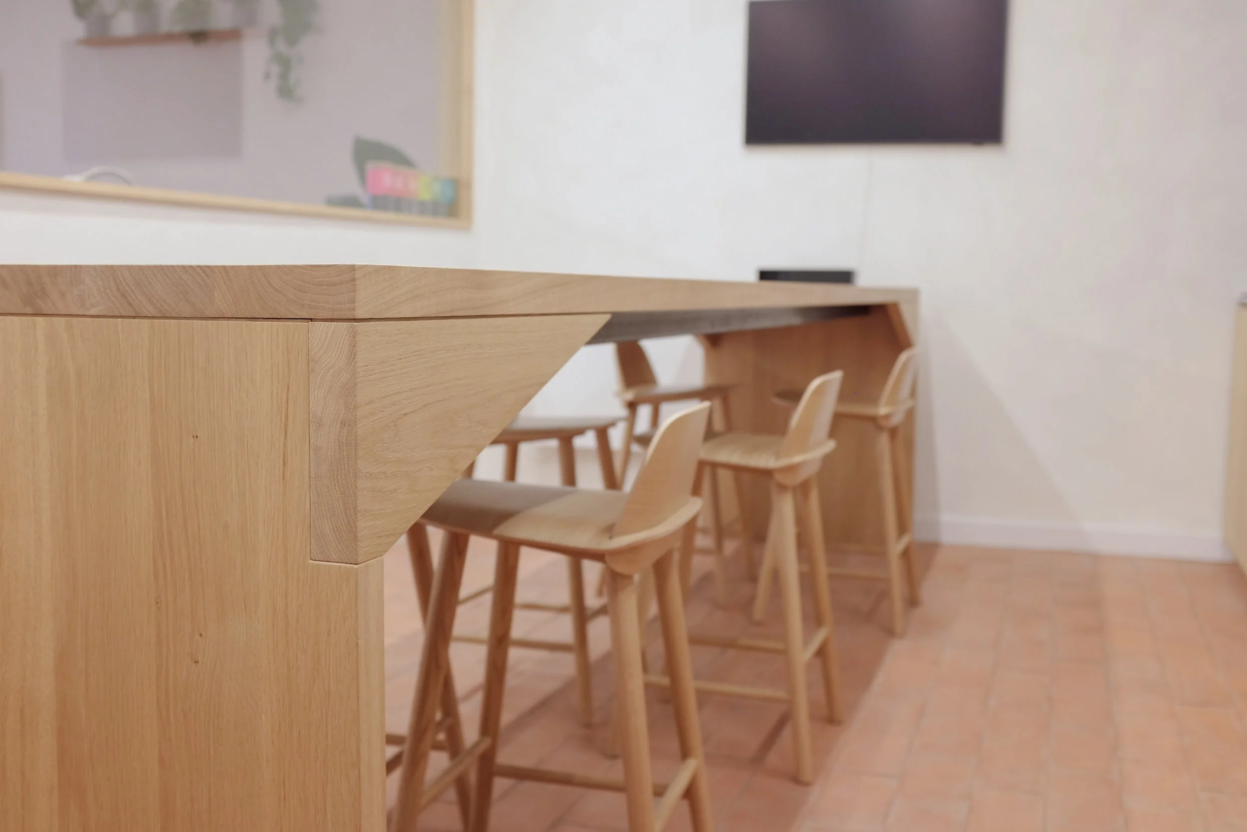 The Origin Bench, four metre long conference table in solid oak with oak stools.