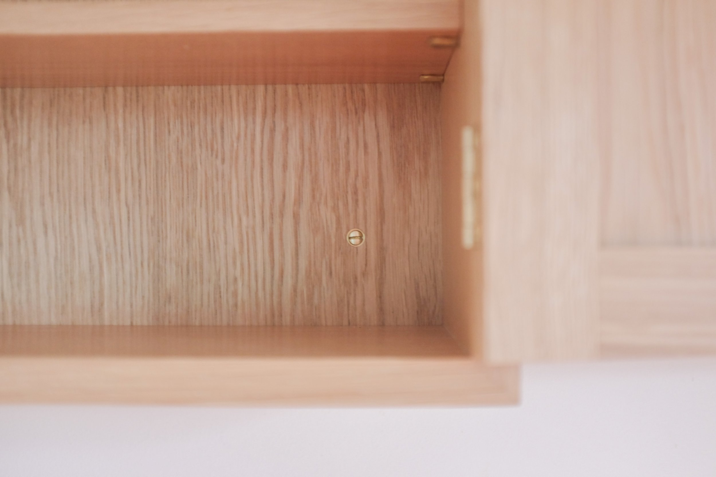 Traditional brass slot screws used to attach cabinet to wall.