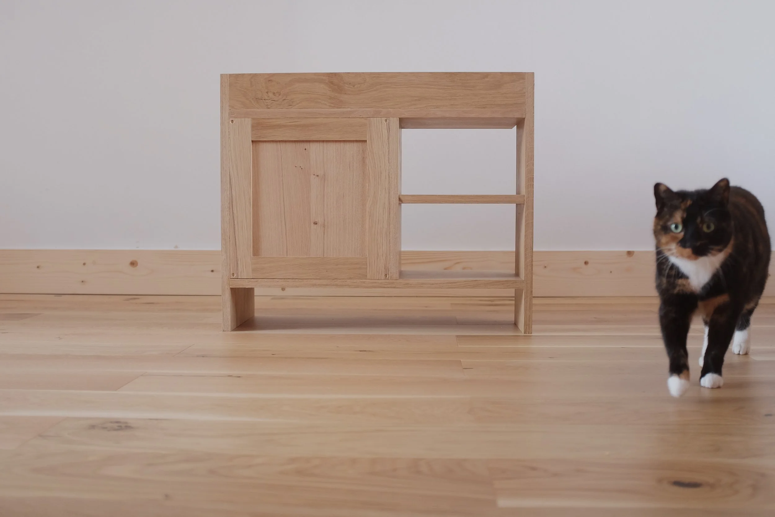 Frame and panel shaker back panel of solid oak bedside cabinet.