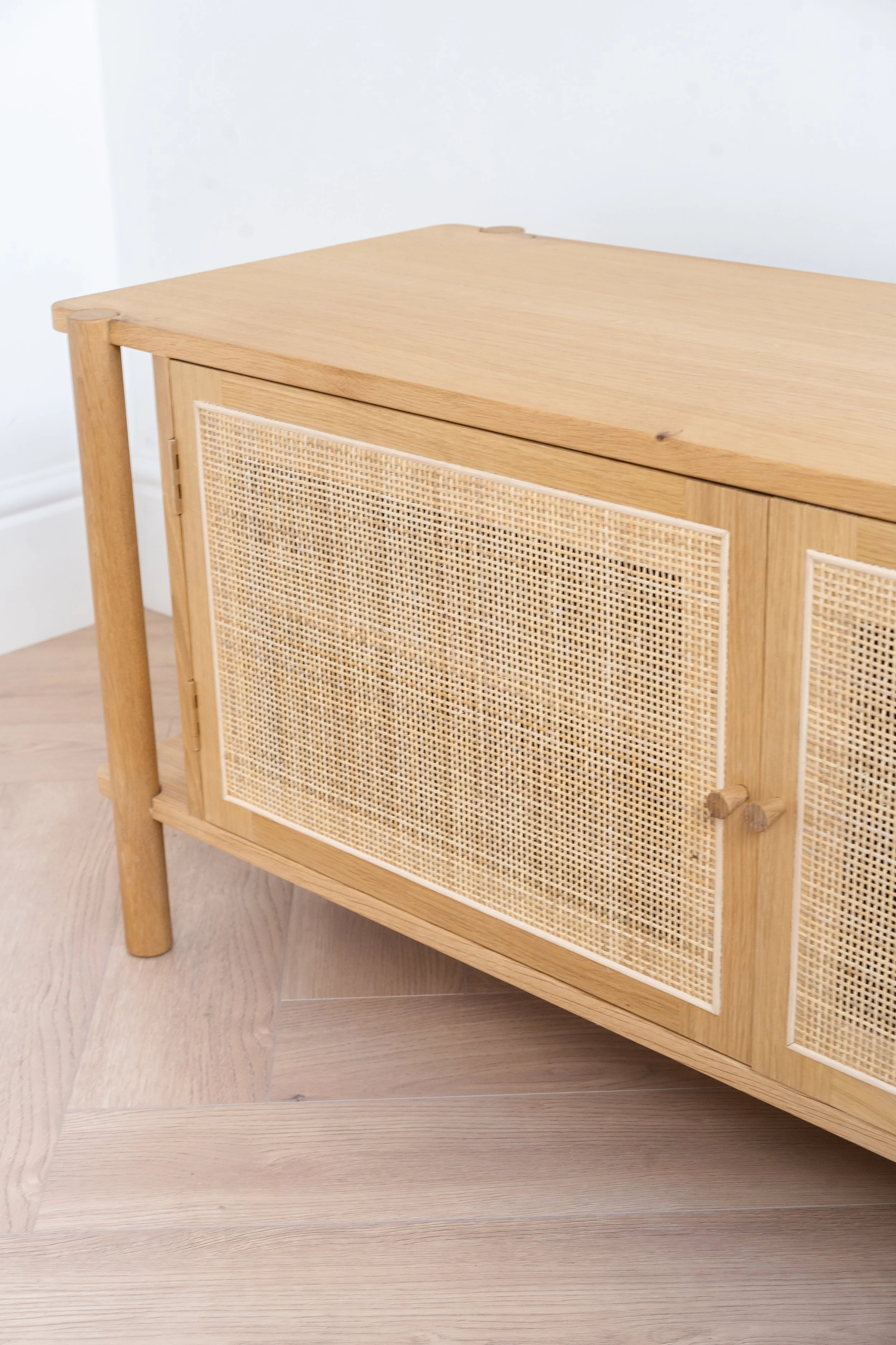 Woven rattan door on oak sideboard.