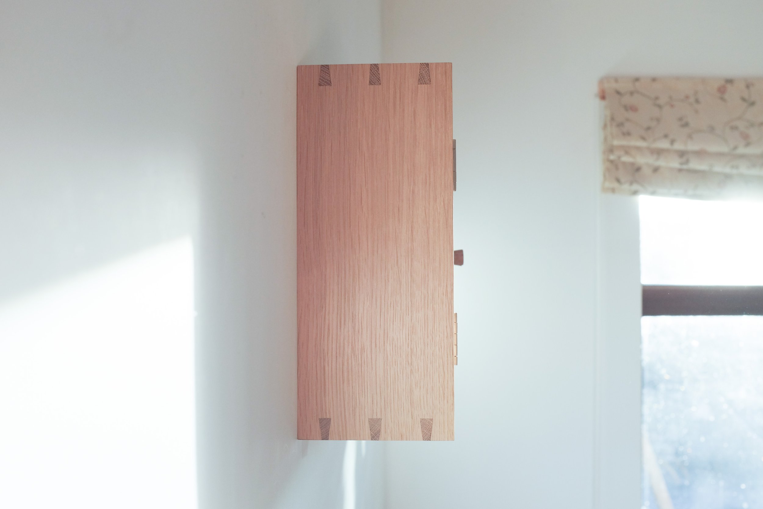 Dovetailed side of wall cabinet.