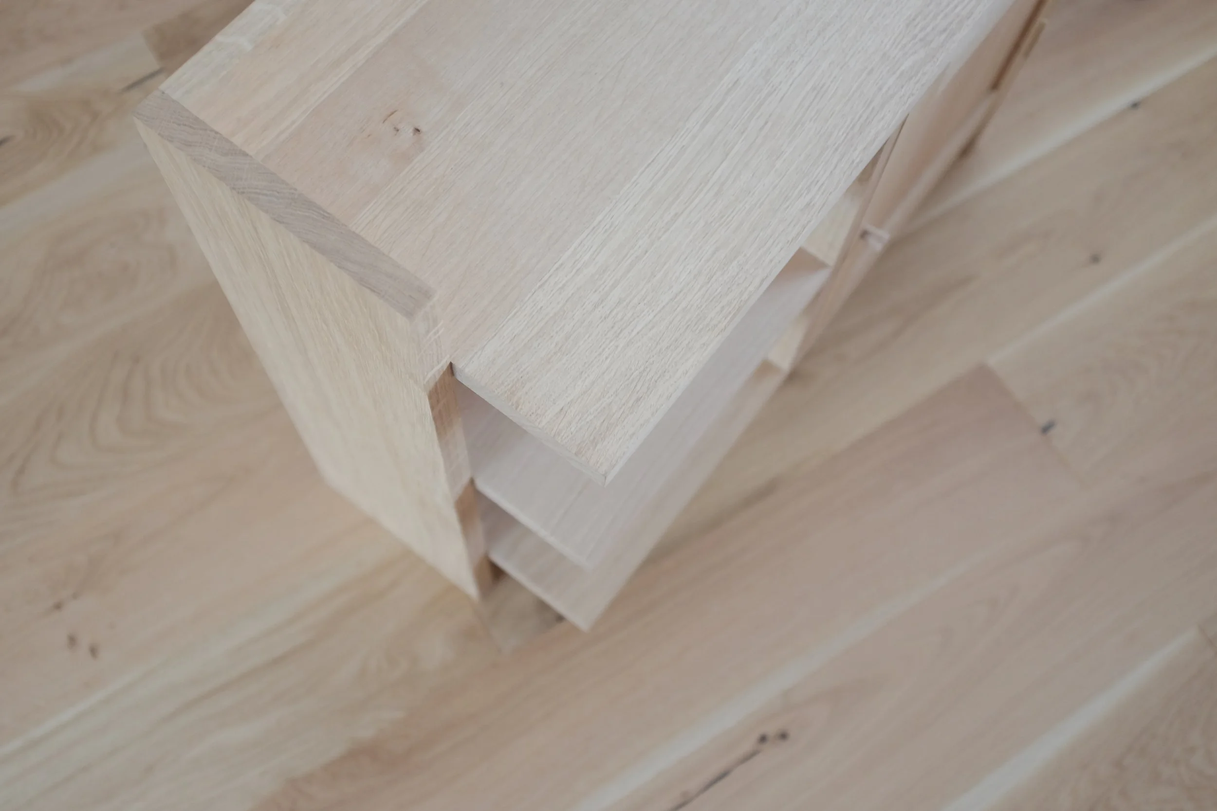 Open shelves on solid oak bedside table.