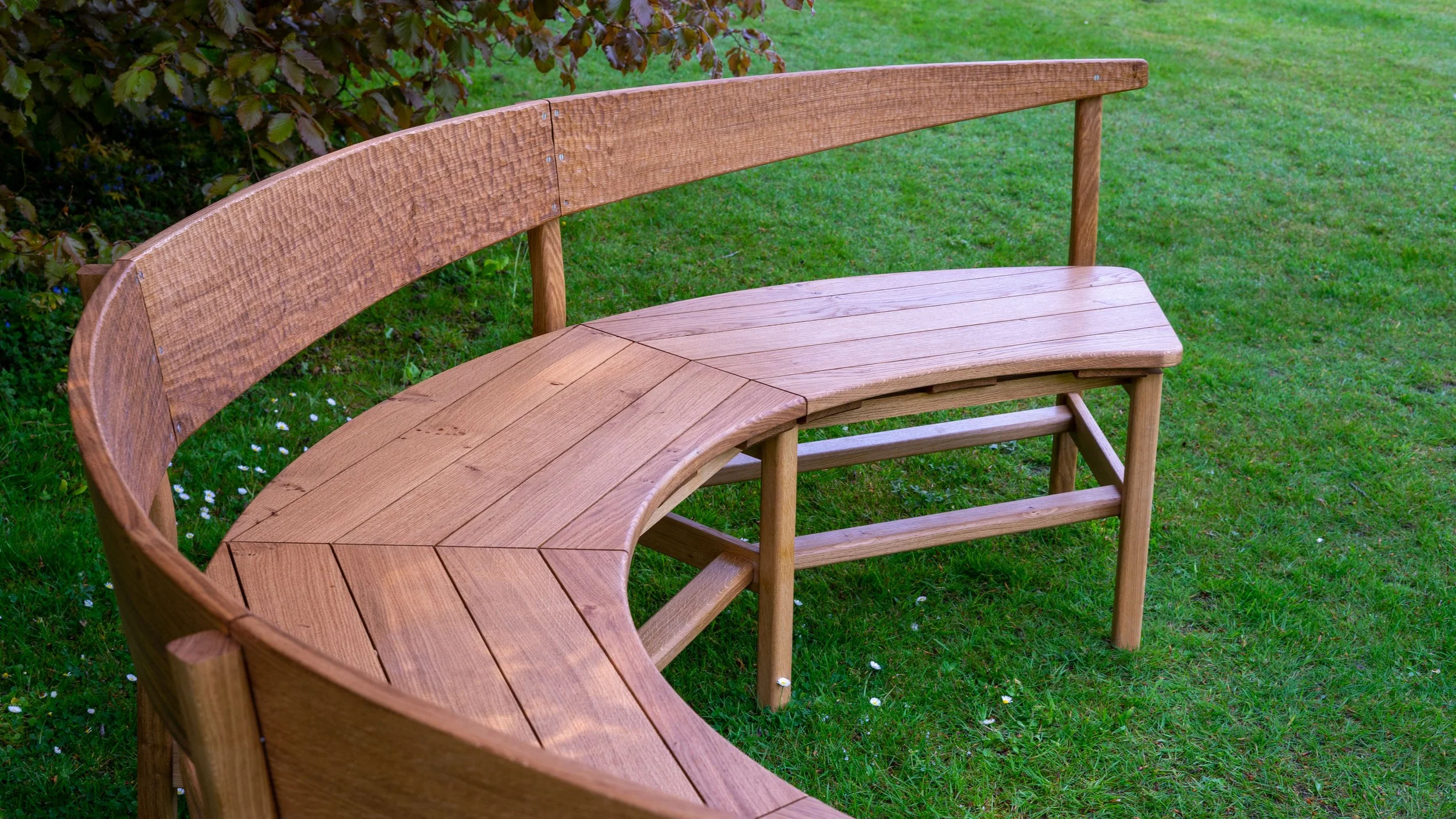The slatted seat design of the solid oak Coln garden bench.