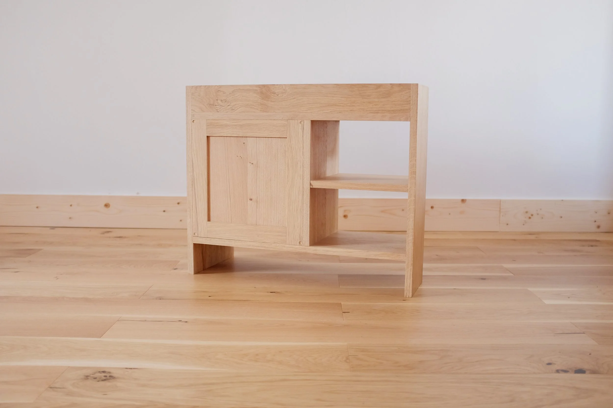 Frame and panel shaker back panel of solid oak bedside cabinet.