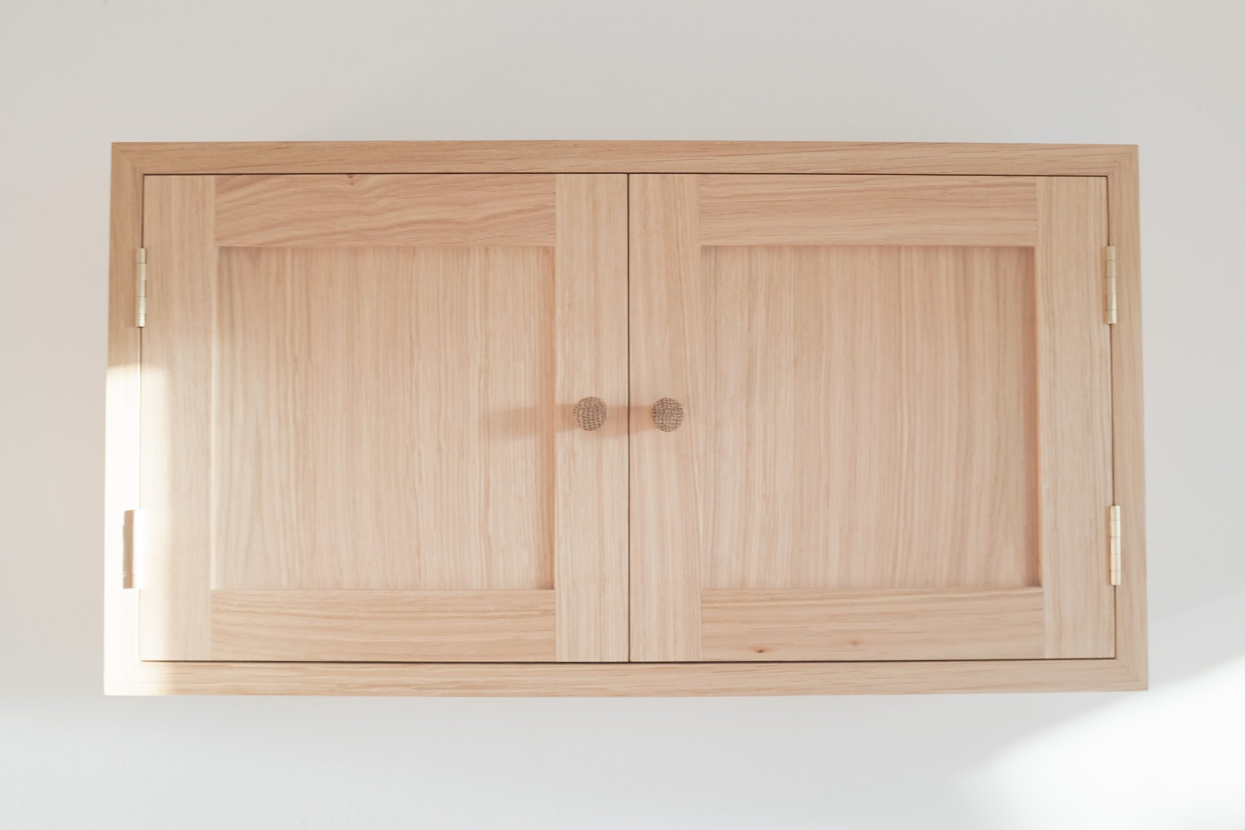 Solid oak shaker doors on wall mounted cabinet.