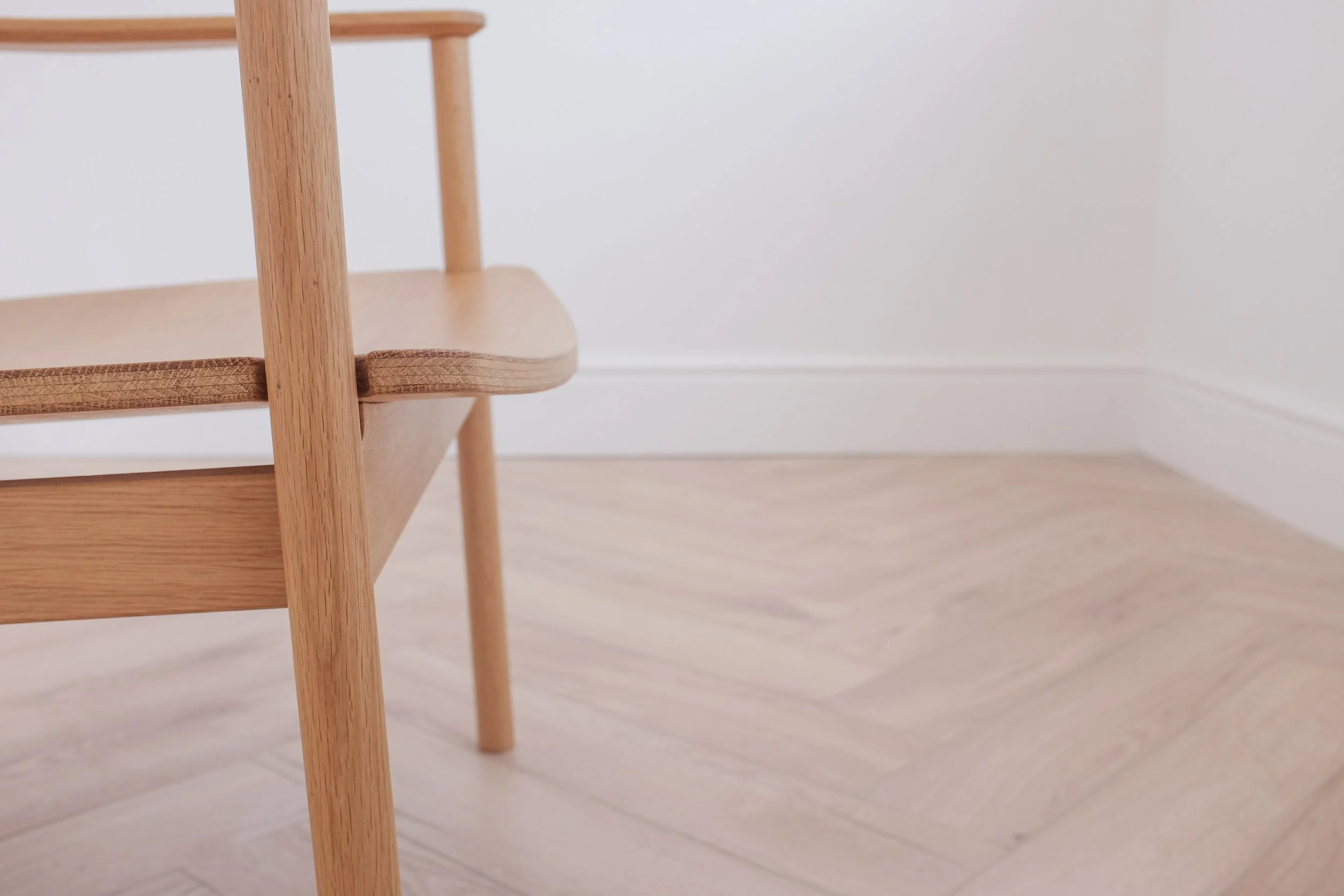 Leg and seat on solid oak easy chair.