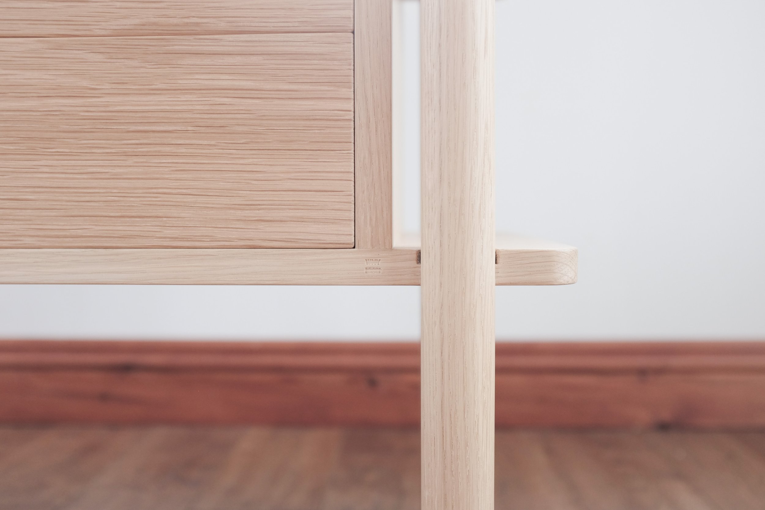 Round oak leg joinery connecting the carcass of the cabinet.