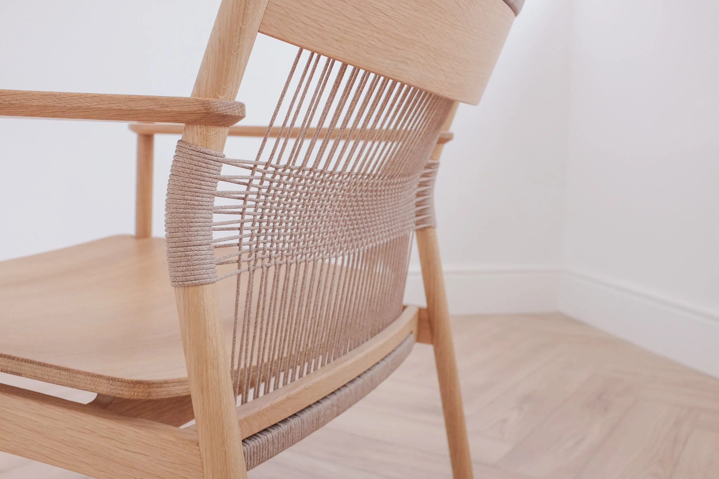 Hand woven backrest on solid oak easy chair.