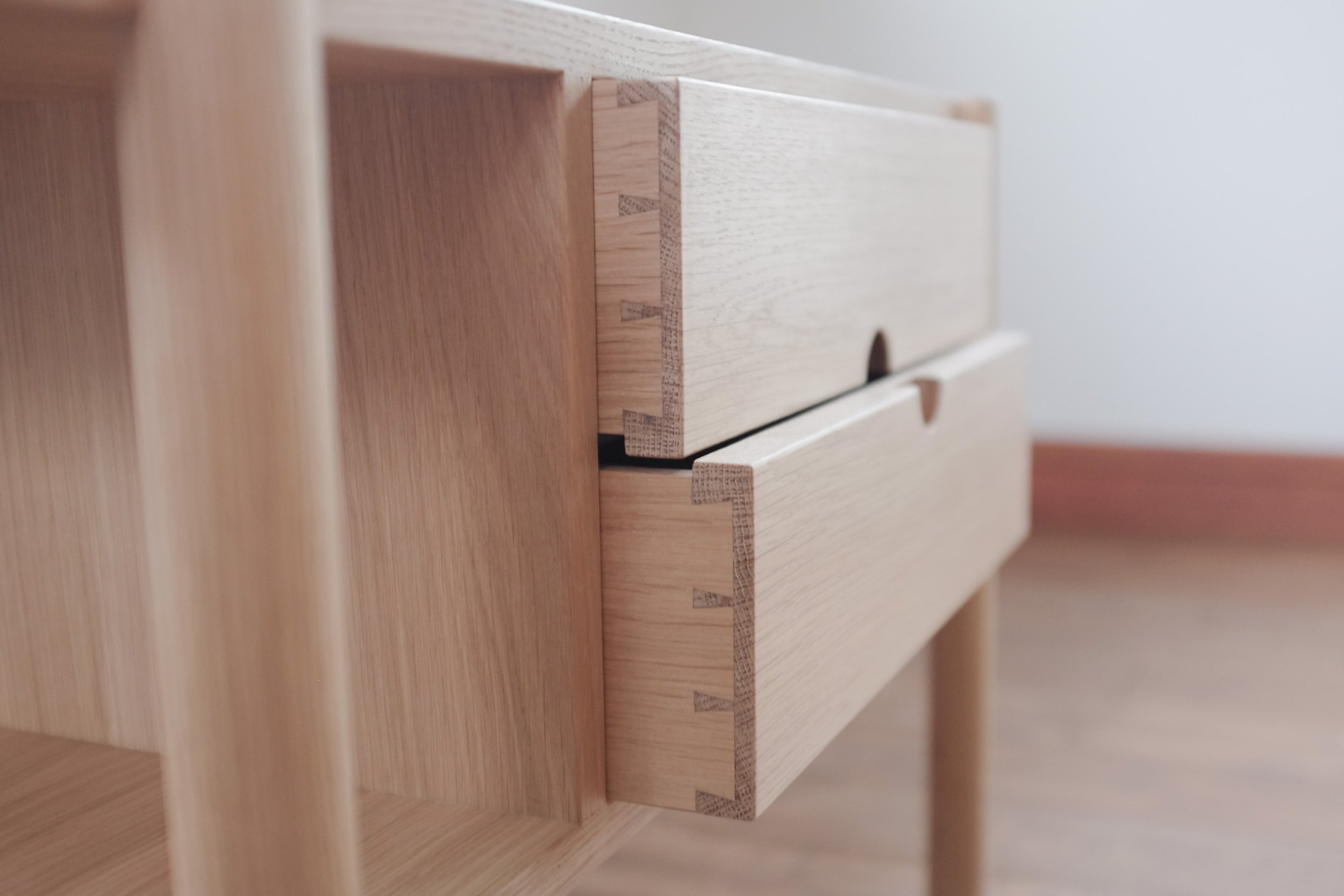 Hand cut dovetail drawers slightly open.