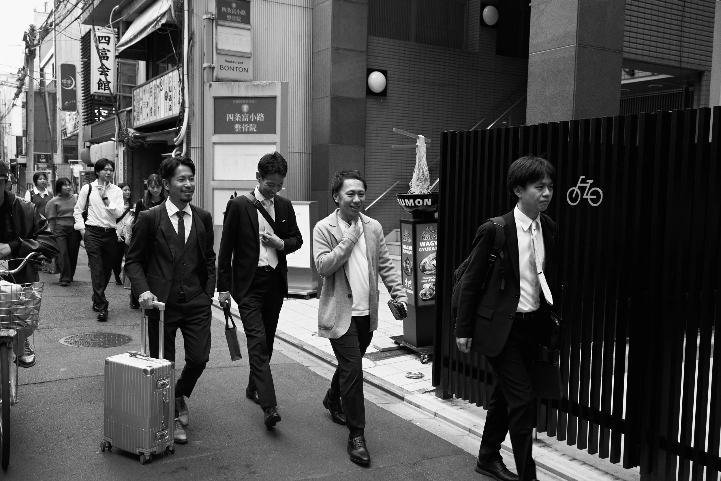 A group of young men walking towards Nishiki Market. Kyoto.