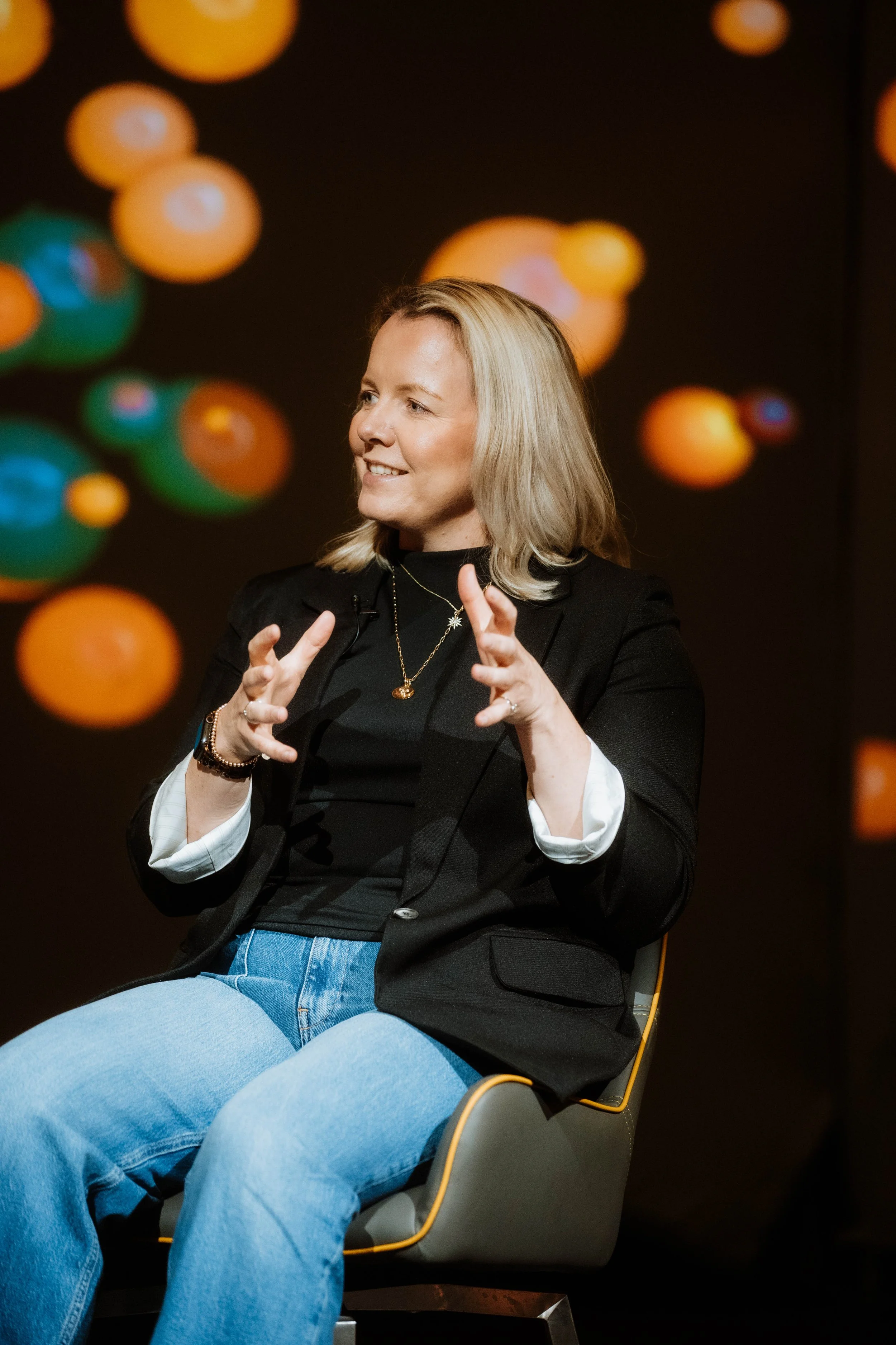 Woman sitting on a stage showing confidence