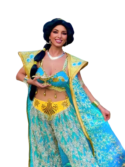 A woman dressed in a colorful, elaborate costume resembling a princess or fairy tale character, with long dark braided hair, holding a gold object, smiling.
