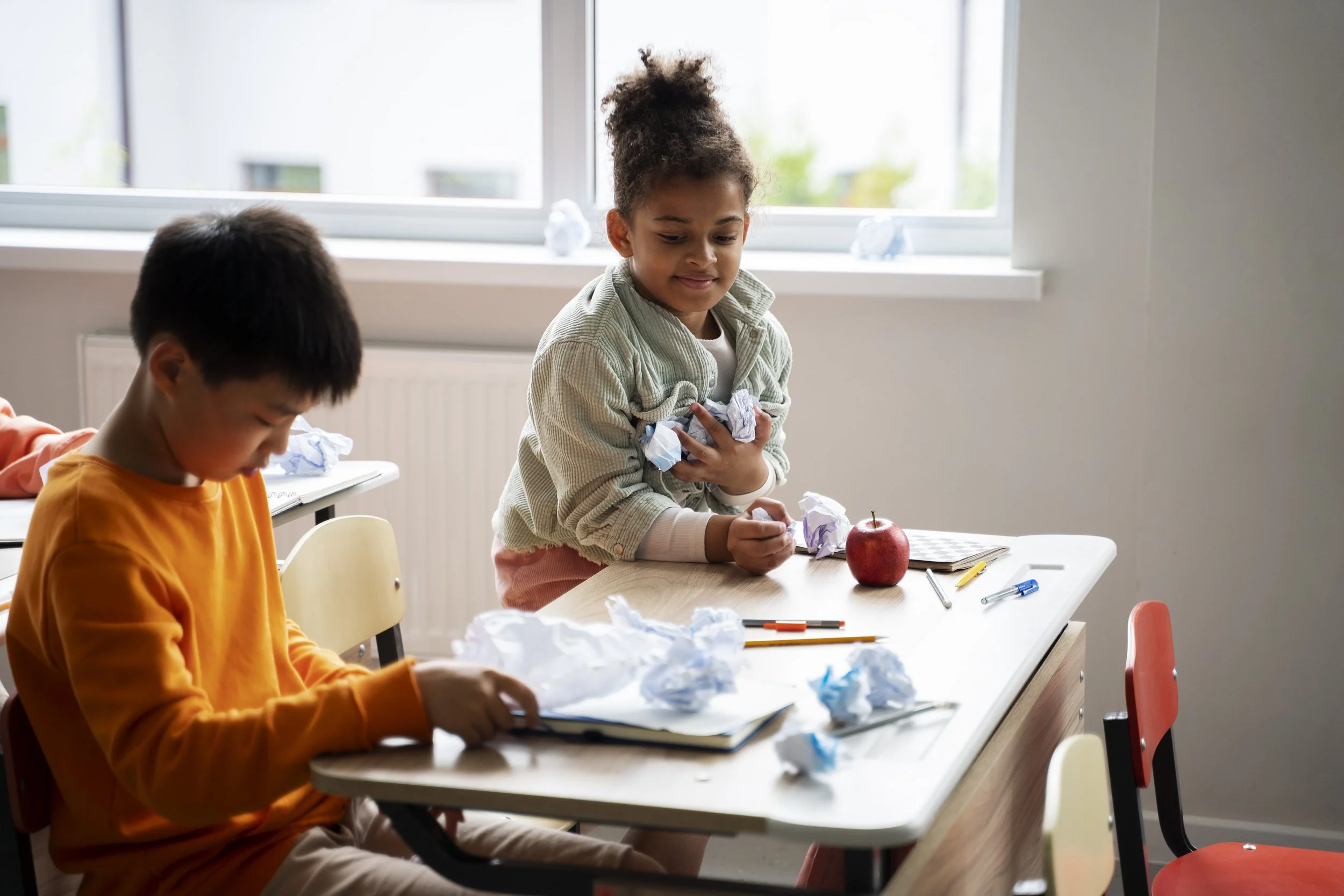 a male and a female kids learning in classroom