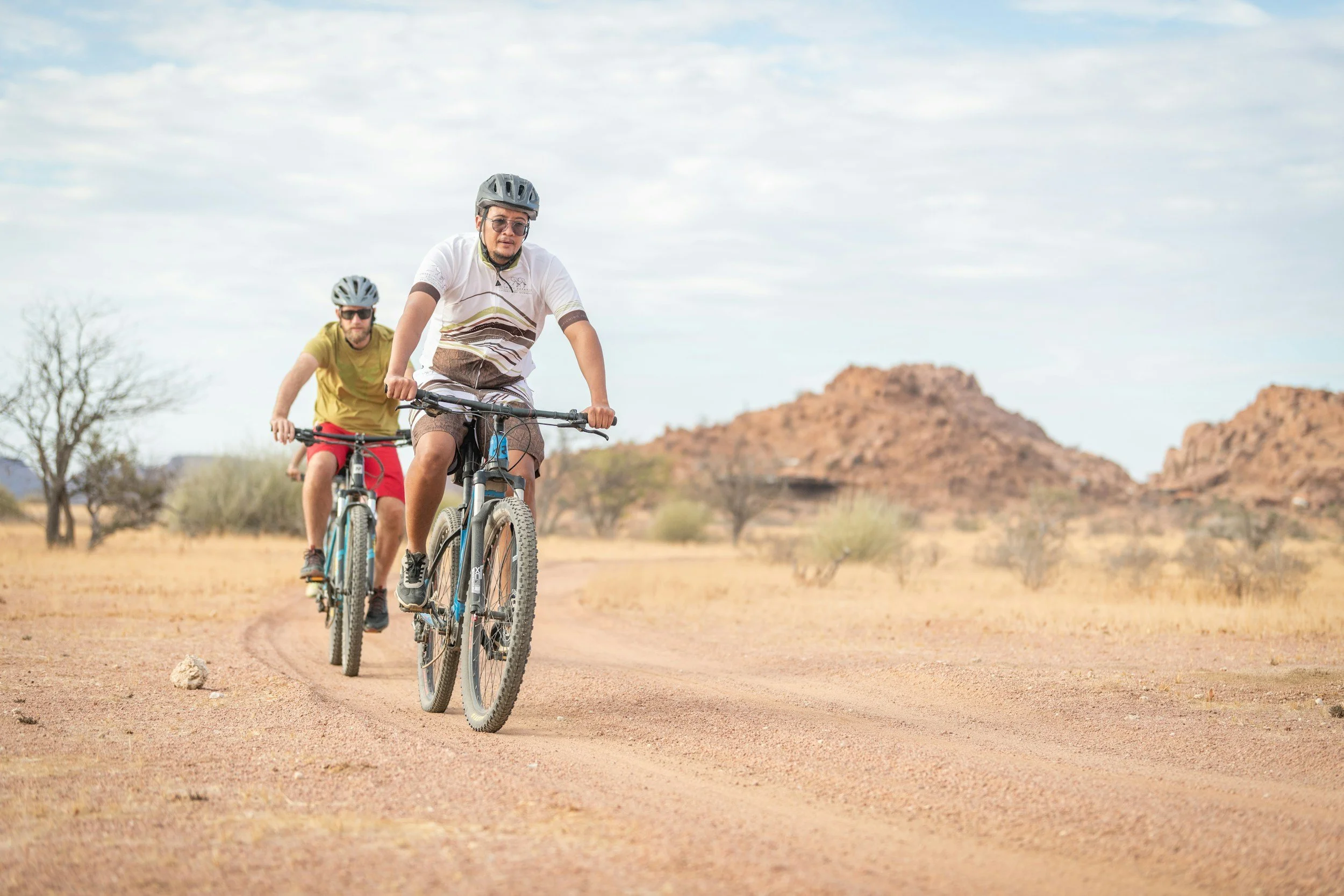 Men riding bikes in Kalahari