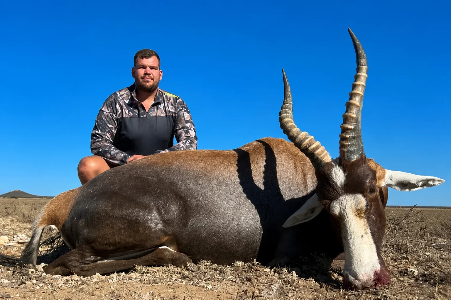 male hunting professional posing with blesbok