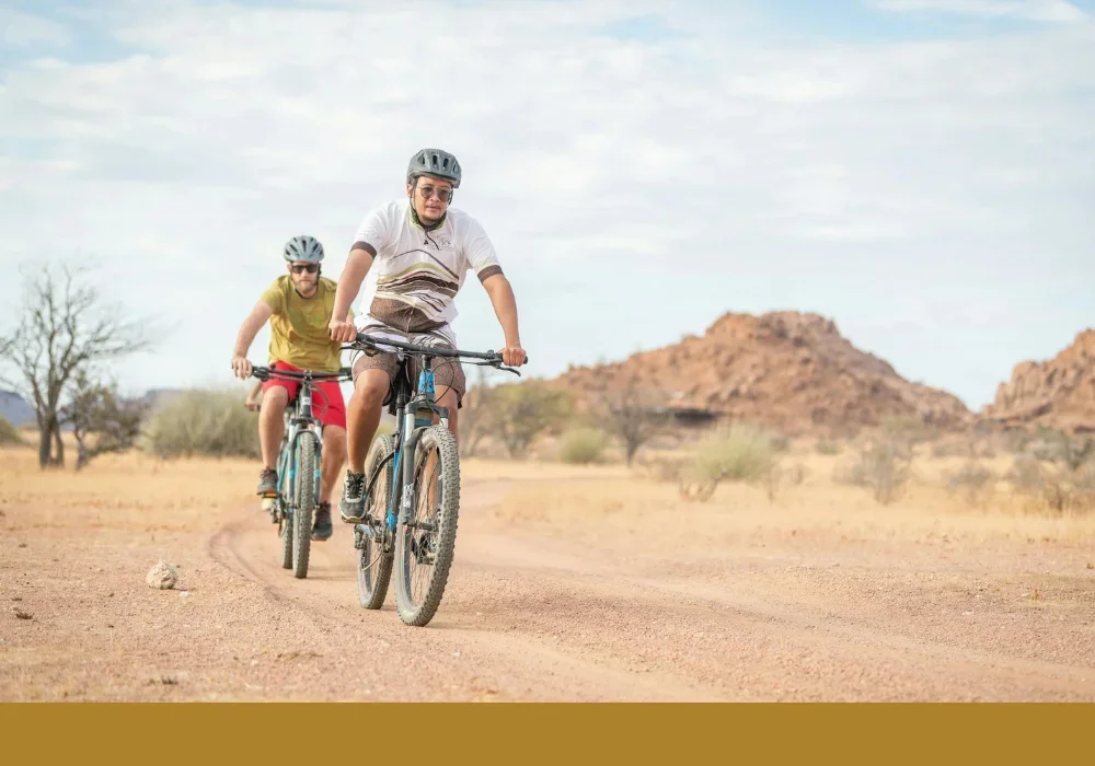 Men riding bikes in Kalahari
