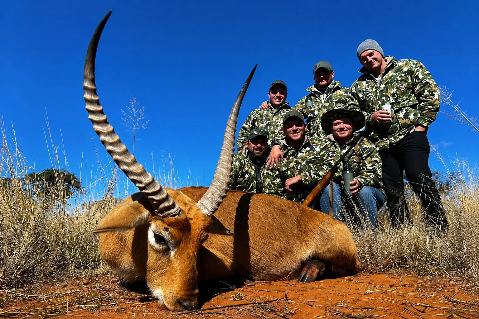 Group of friends smiling with Lechwe Bull