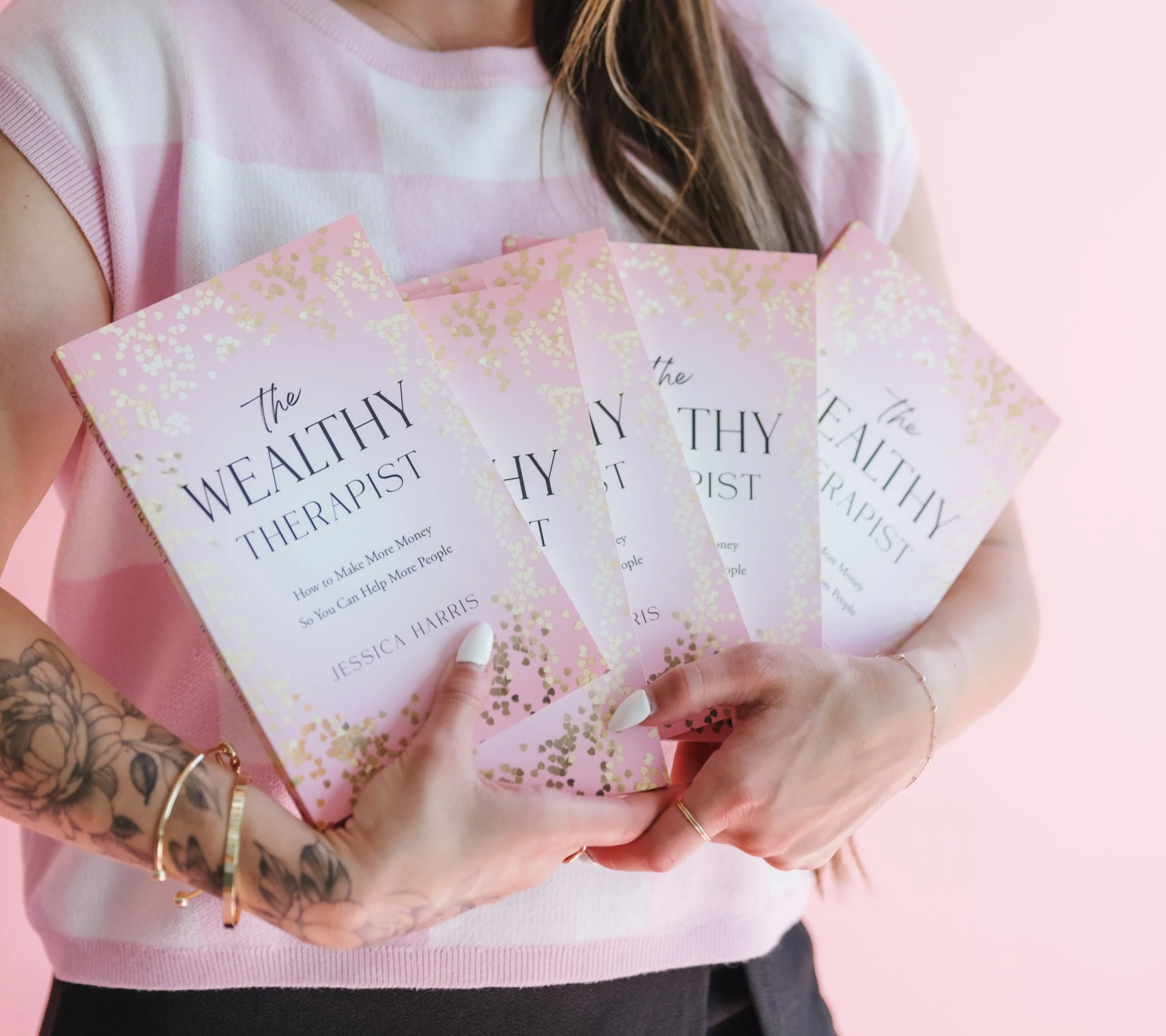 Jessica Harris holding a copy of The Wealthy Therapist