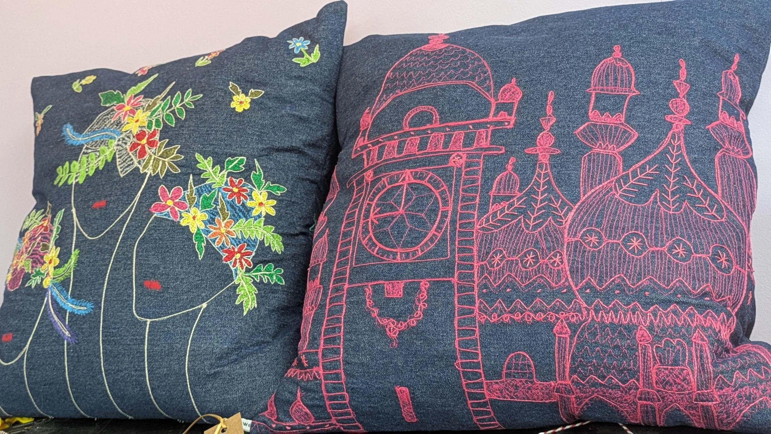 hand embroidered cushions featuring floral and architectural designs 