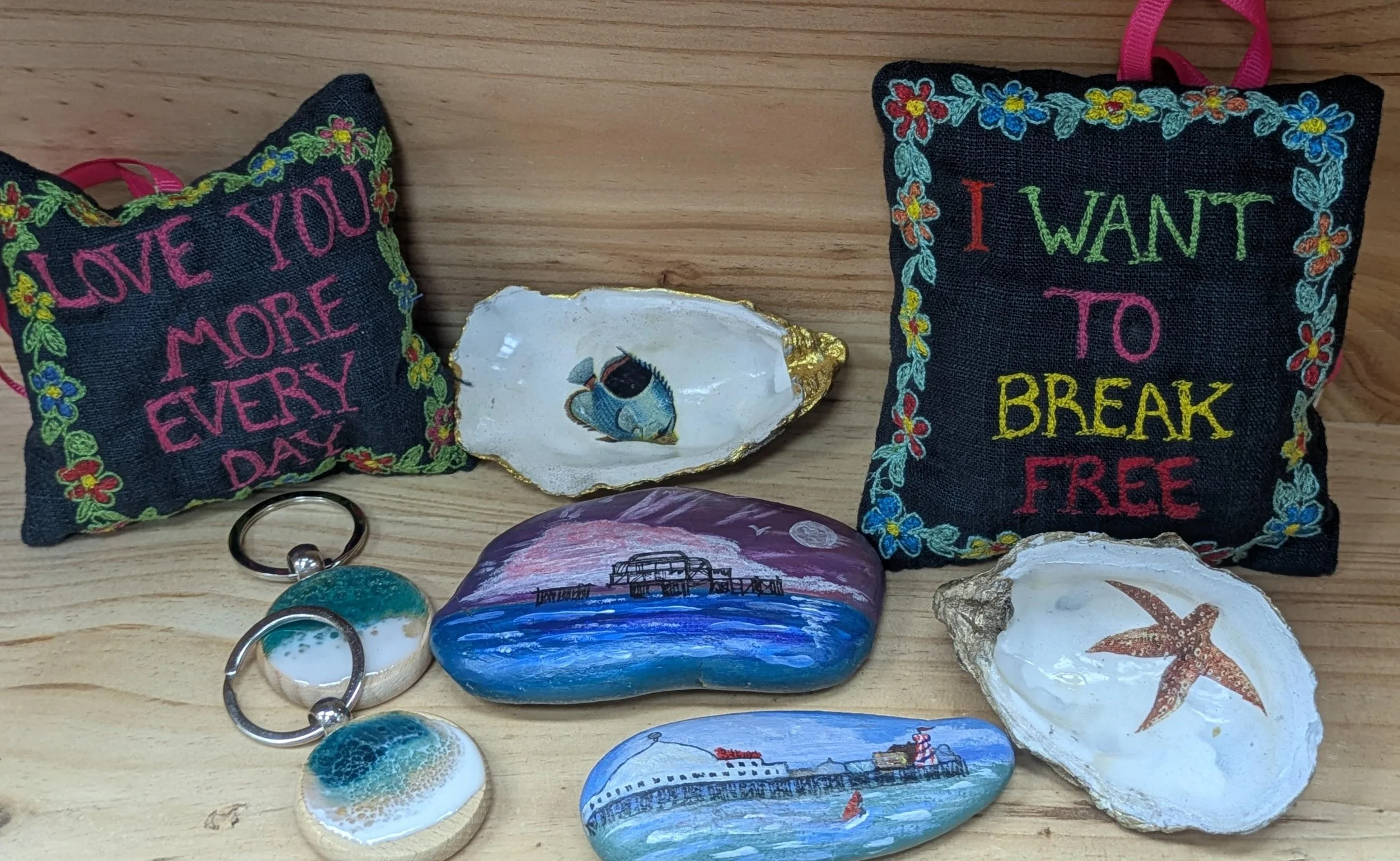 handmade embroidered cushions with painted shells, seaside stones and ocean themed keychains