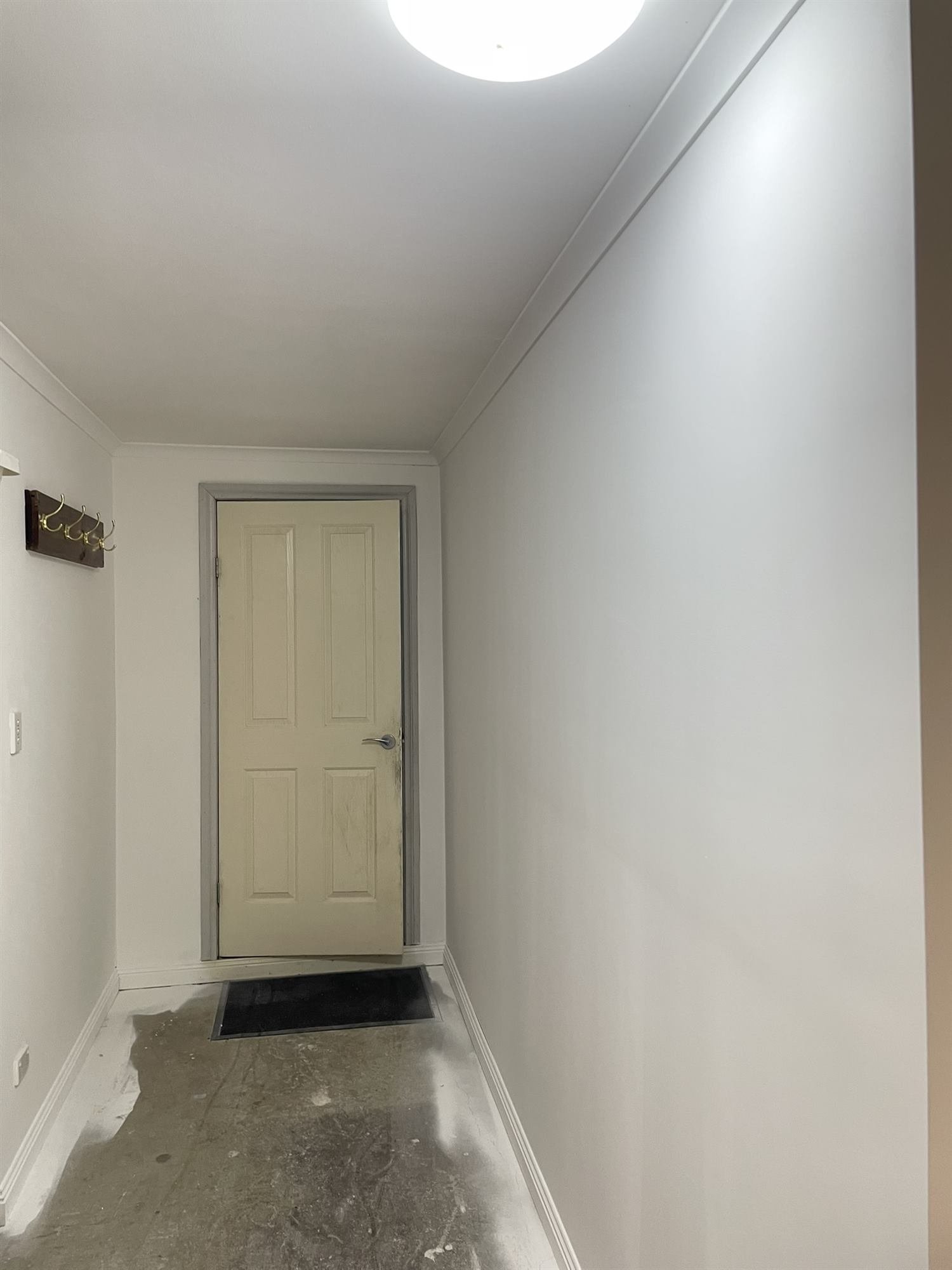 Freshly painted white hallway and door in a new house extension, Croydon