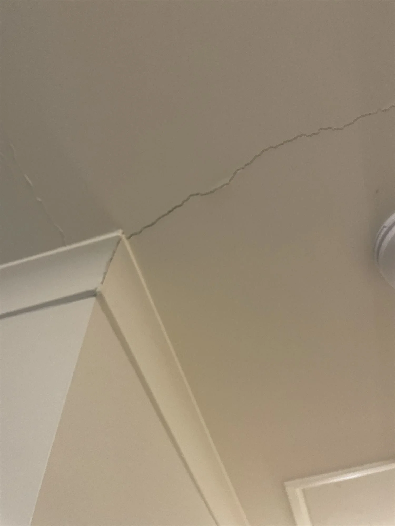 Crack running across a ceiling corner before repair