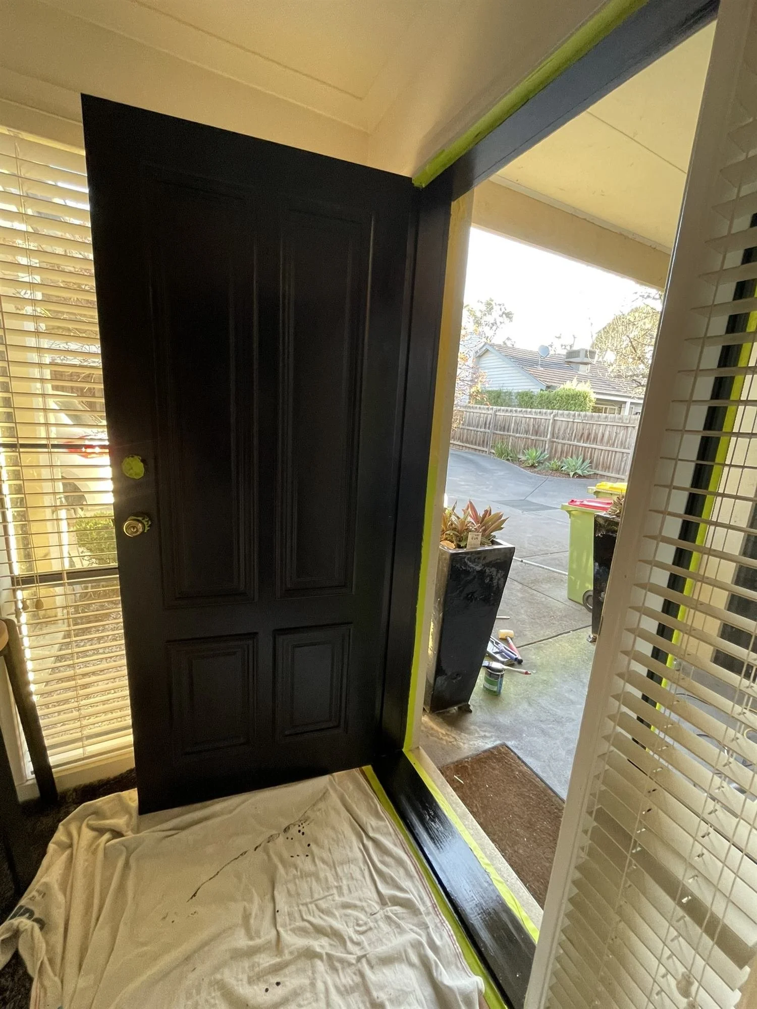 Black gloss front door and frame with masking tape still in place