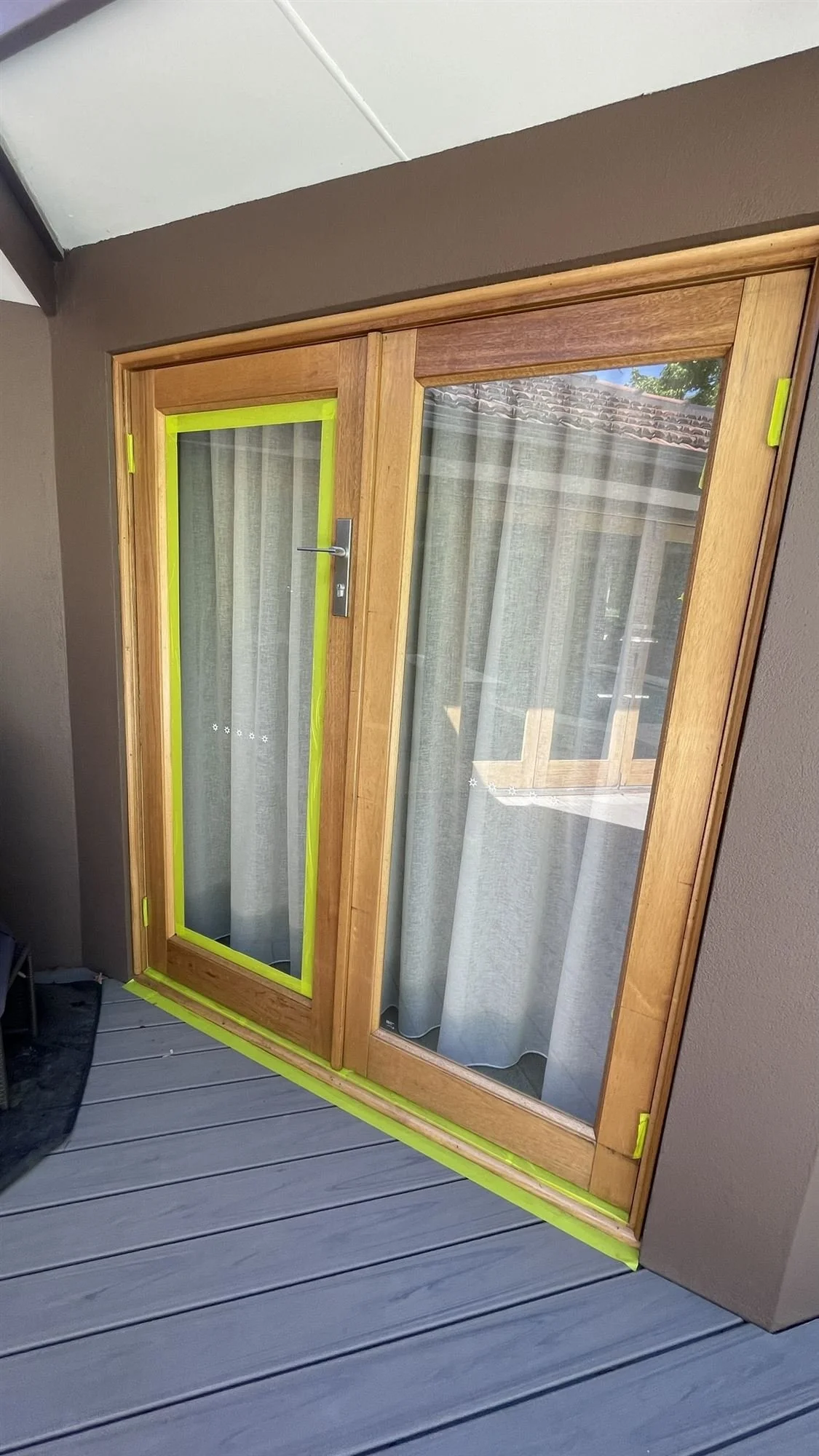 Timber French doors masked around the glass before recoating