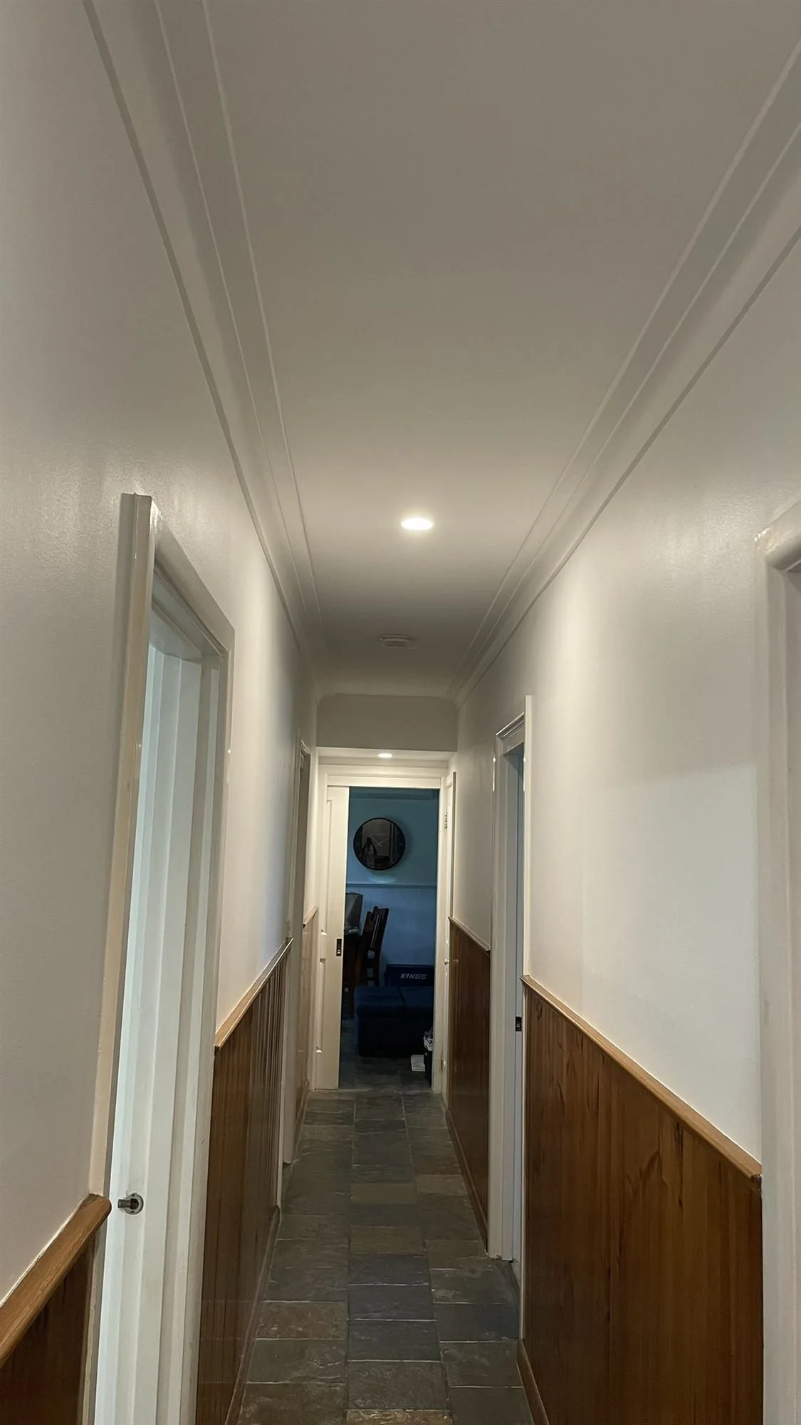 Long hallway with freshly painted white walls and ceiling