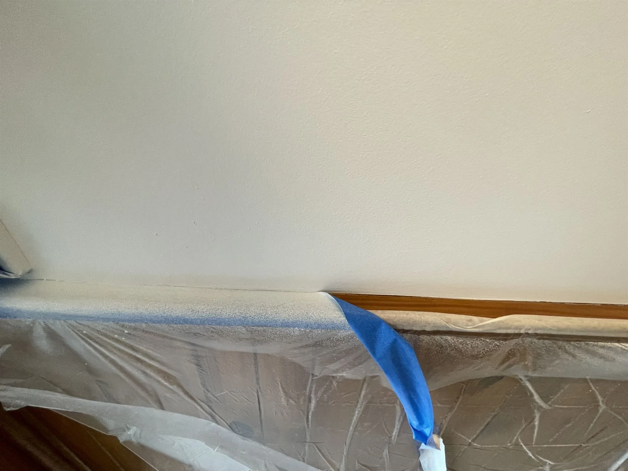 Timber dado rail masked with tape before painting the wall above