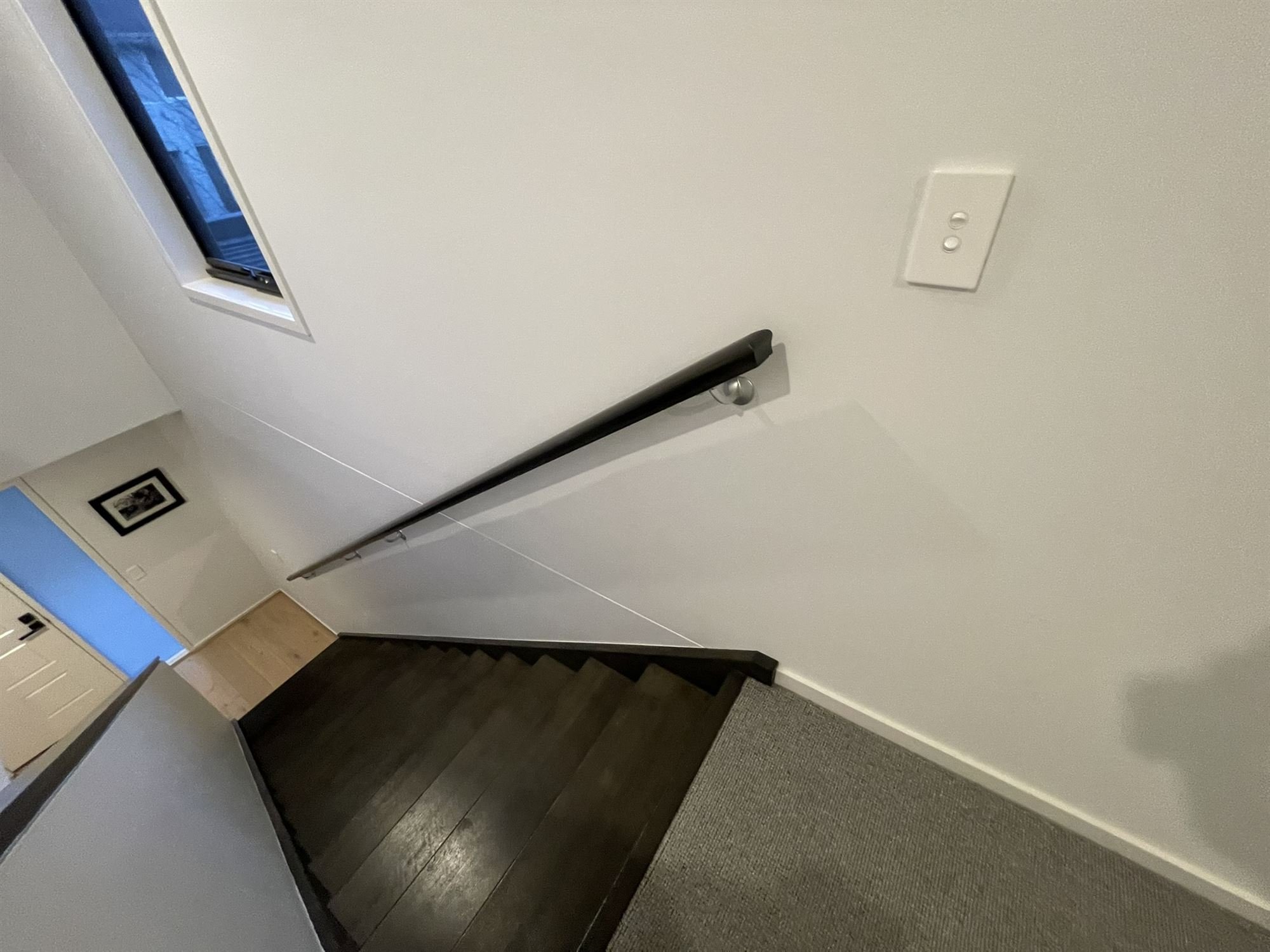 Freshly painted stairwell wall and handrail