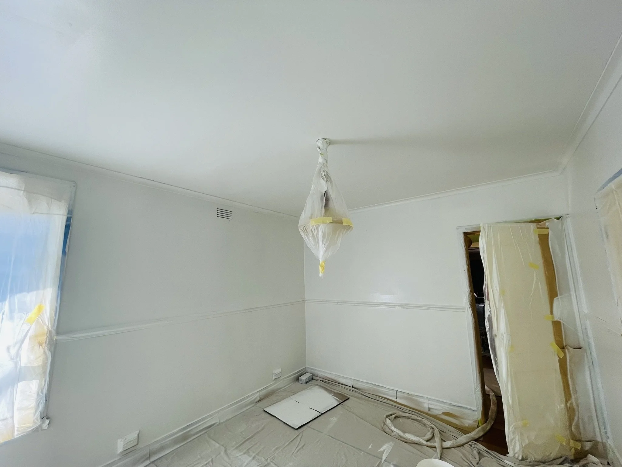 Bedroom mid-repaint with windows, door and light fitting masked, Croydon Paintworks interior repaint, Melbourne