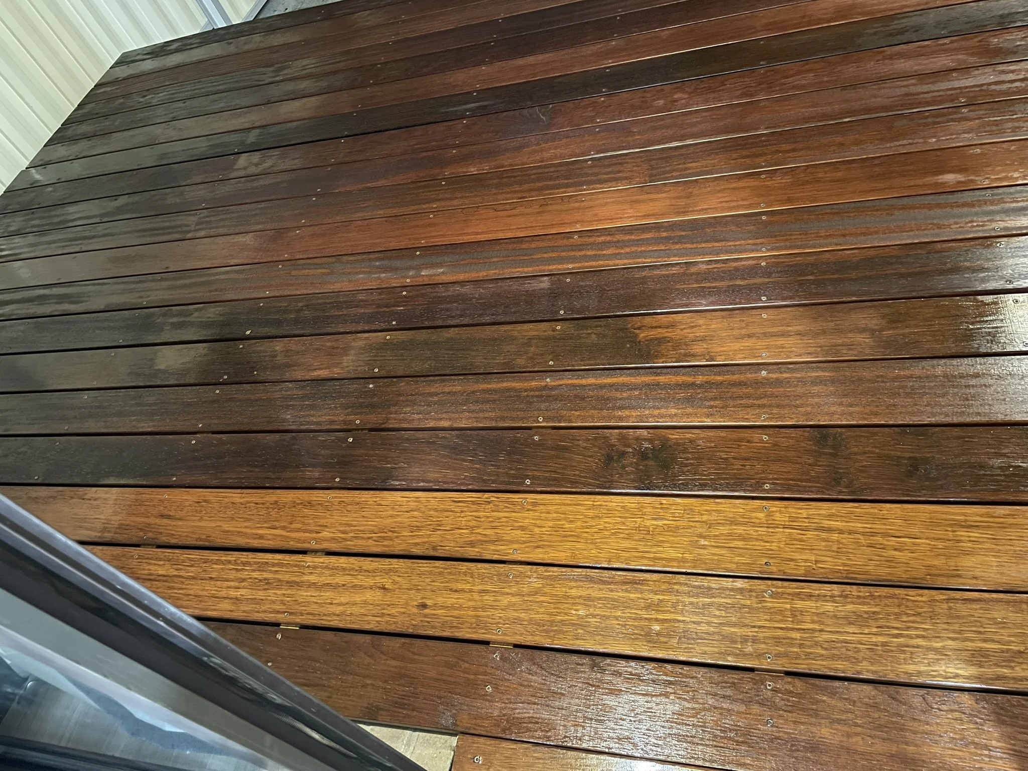 Timber deck part-way through oiling, showing freshly oiled boards beside weathered ones, Croydon Paintworks, Melbourne