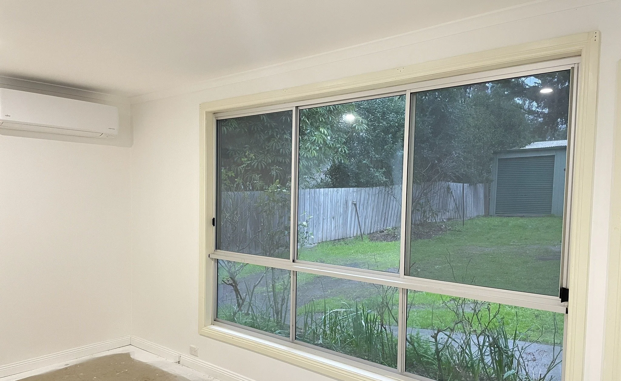 Freshly painted white living room walls and ceiling with large window, Croydon