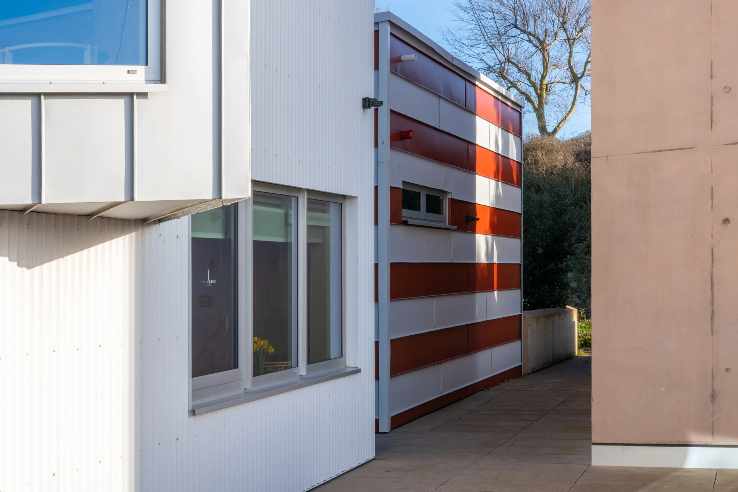 East Quay Watchet exterior view through gap in buildings leading to path with tree