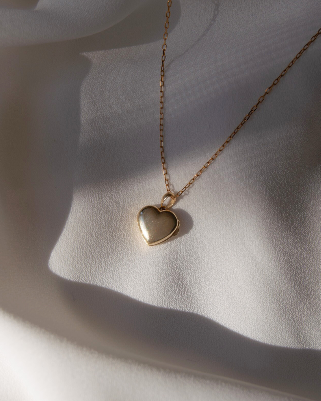 solid gold heart locket.png