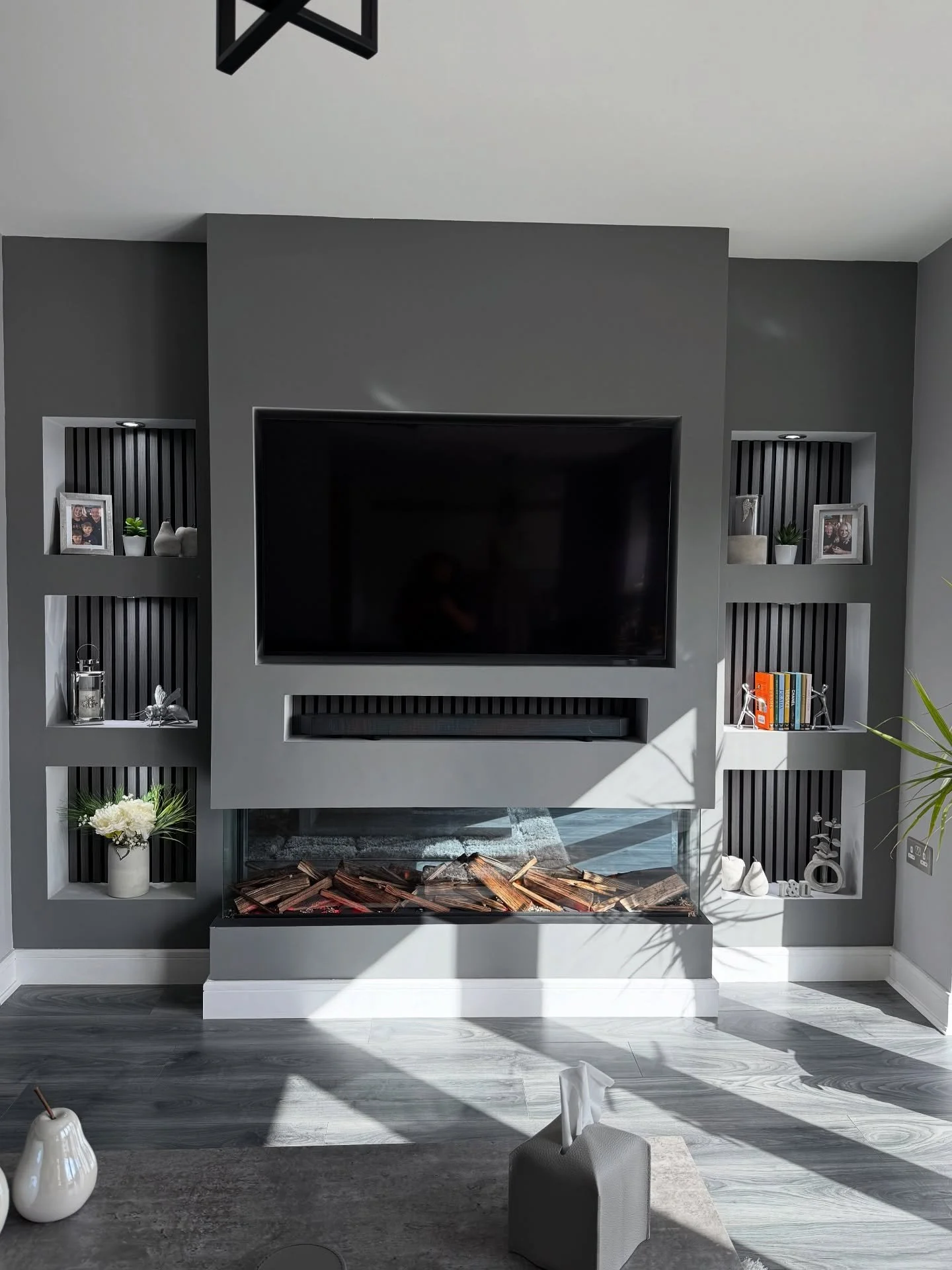 ✨ Modern Media Wall Reveal ✨

We&rsquo;ve just completed this stunning feature wall for our lovely clients, Trish &amp; Den 🙌

✔️ Sleek acoustic panelling to the alcoves
✔️ Spotlights to create a warm glow
✔️ A stylish 3-sided fire
✔️ All cables &am