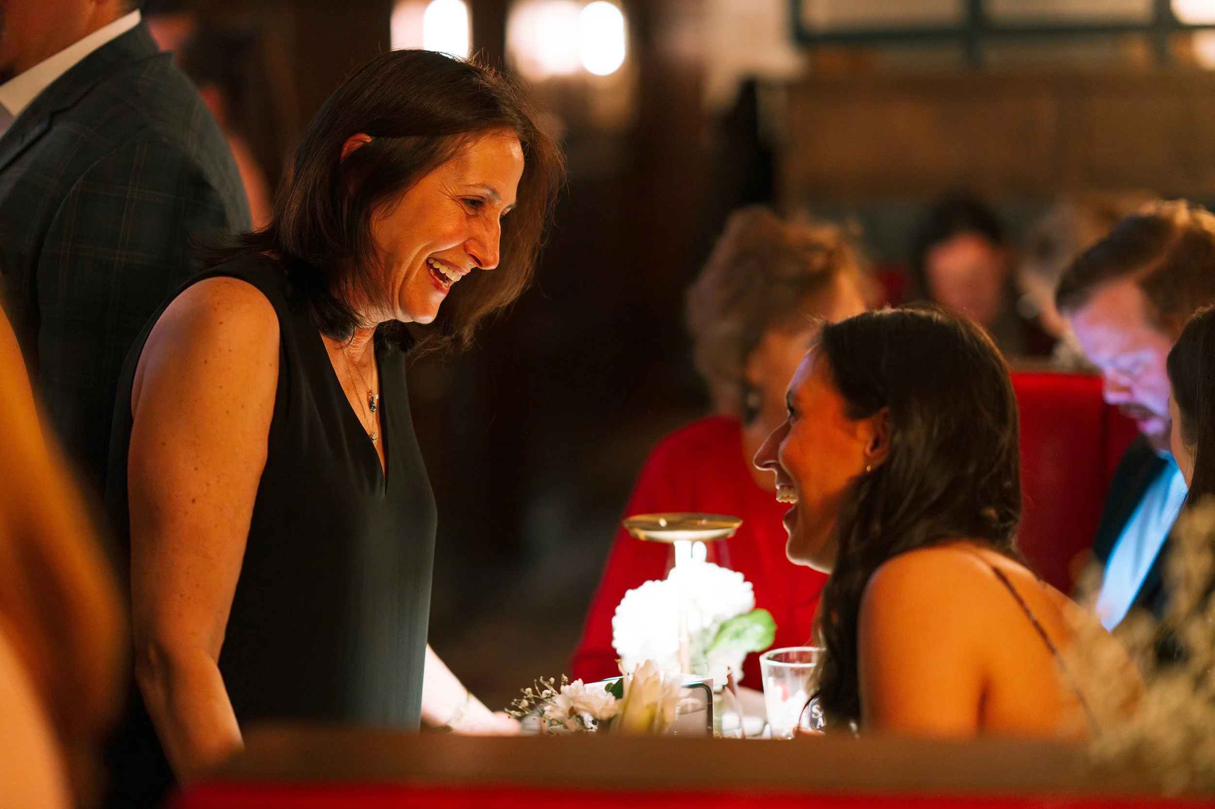 Two women laughing together at a party