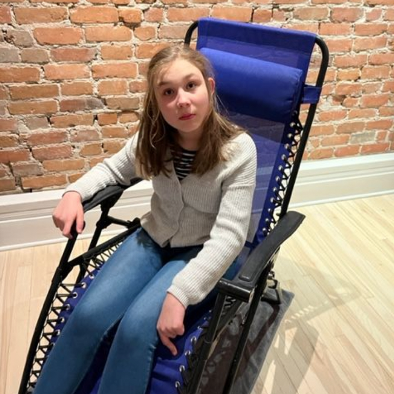 Sacha sitting in an armchair