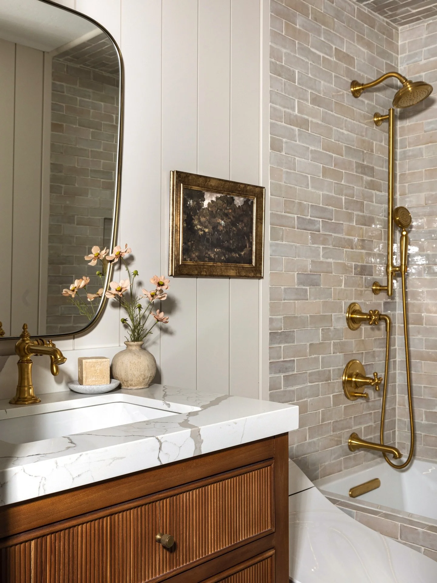 This bathroom transformation at our Wren Hollow remodel will never get old! 

A full gut renovation allowed us to completely reimagine the space with a softer palette, handcrafted zellige, and brass plumbing that feels timeless rather than trendy. Th
