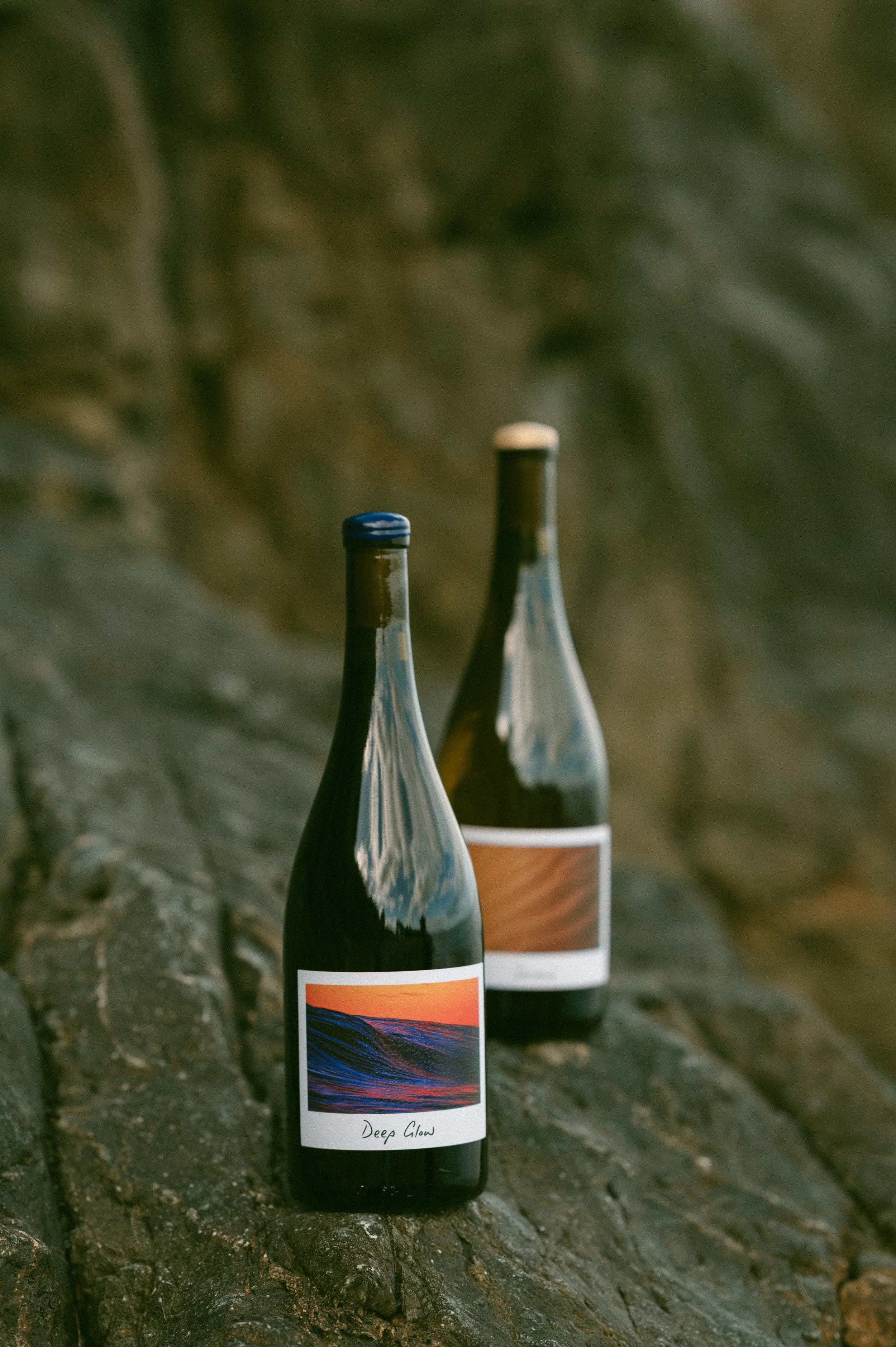 A wood-textured wine barrel label with the text 'ANA Selection France Venus M 3Y 2024' and a circular logo with a small circle and wavy lines, representing a landscape or horizon.