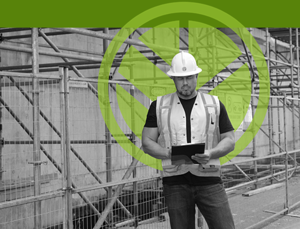 A construction worker wearing a safety helmet and vest, holding a clipboard, standing on a construction site with scaffolding and safety barriers, overlaid with a green no-entry symbol.