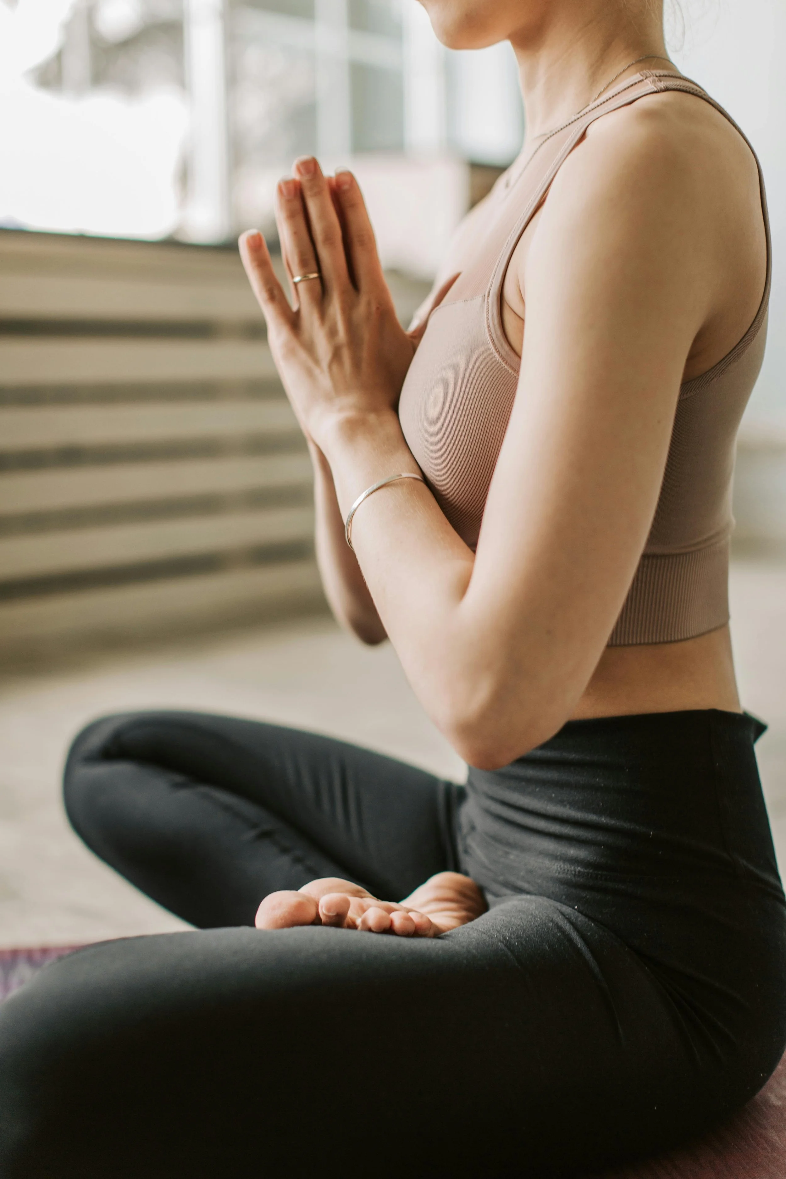 Woman in prayer hands yoga pose focussing on the mind/body perspective