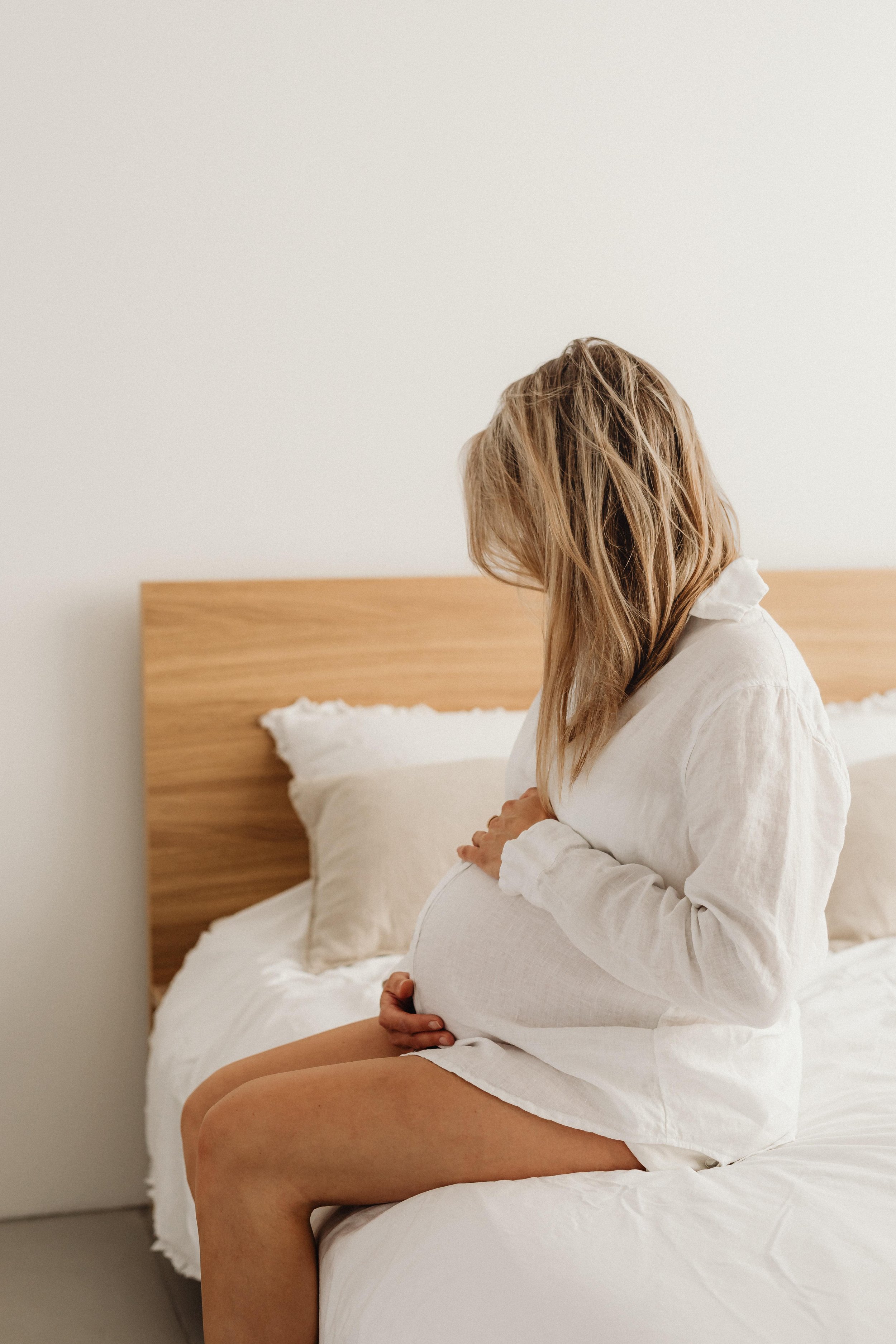 Pregnant woman holding belly after optimising her fertility