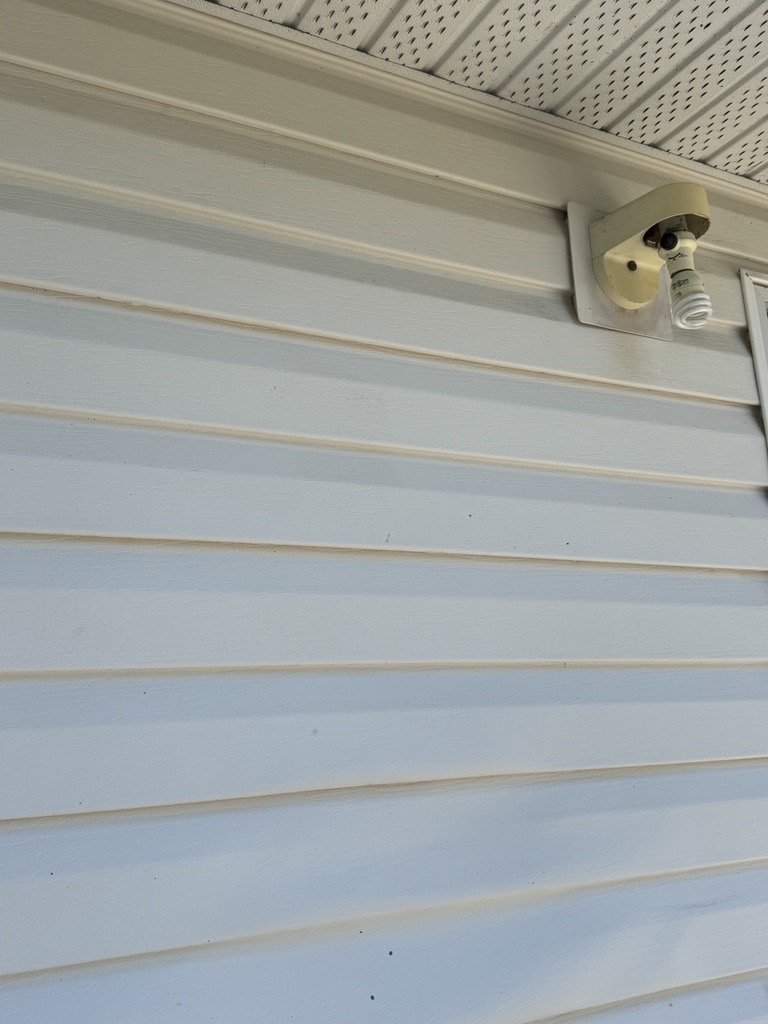 A before-and-after photo shows the dramatic results of JBM Custom Contracting's wall cleaning service. The left side reveals a dirty, grimy wall, while the right side displays a spotless, rejuvenated surface, highlighting the effectiveness of our cle