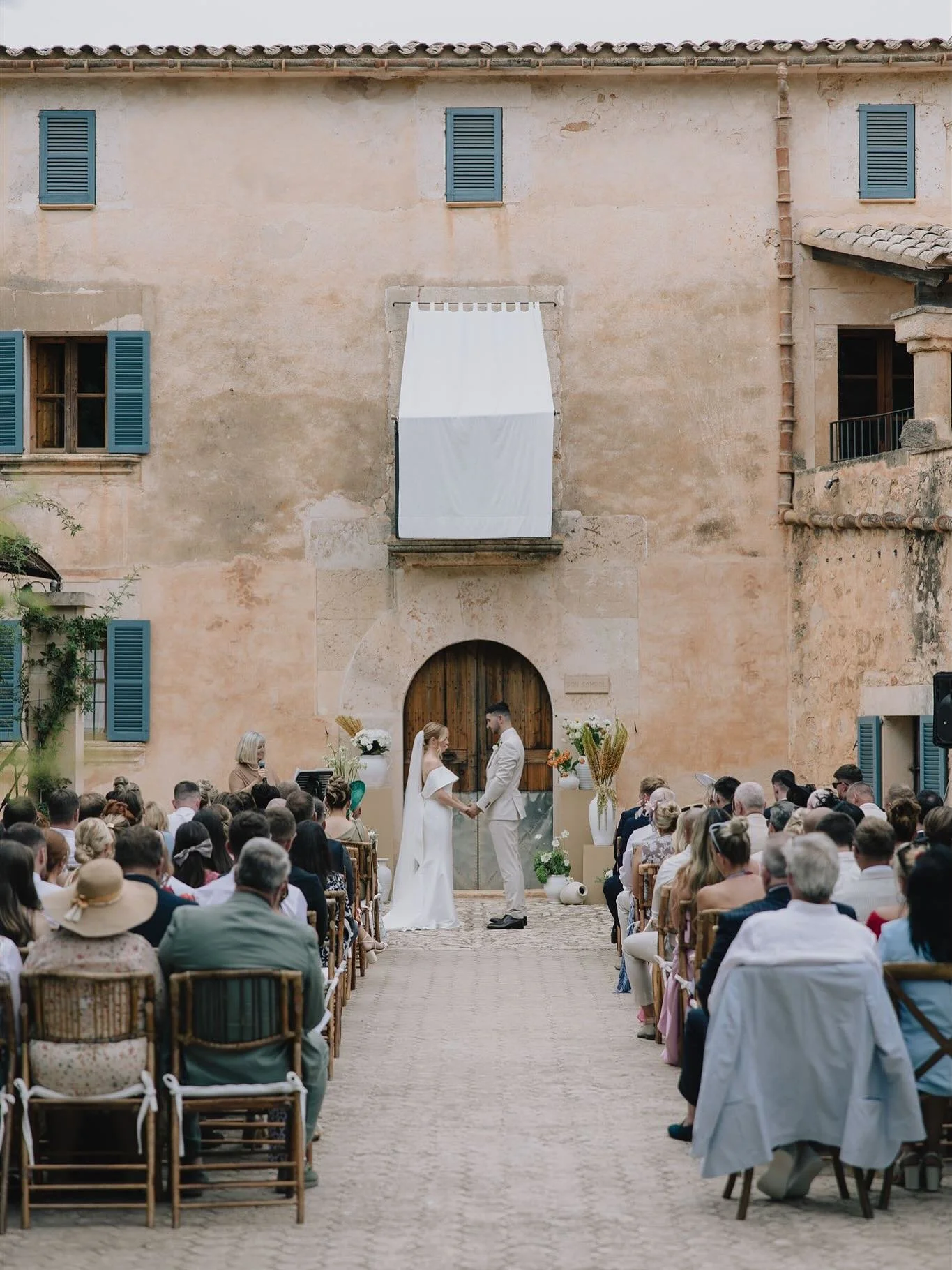 For E&amp;J&rsquo;s ceremony set against a stunning Mallorcan villa, we chose to have pops of colour on bespoke neutral bases that let the florals do all the talking. 

Their tablescape was made that bit more playful by adding colour through mixed gl