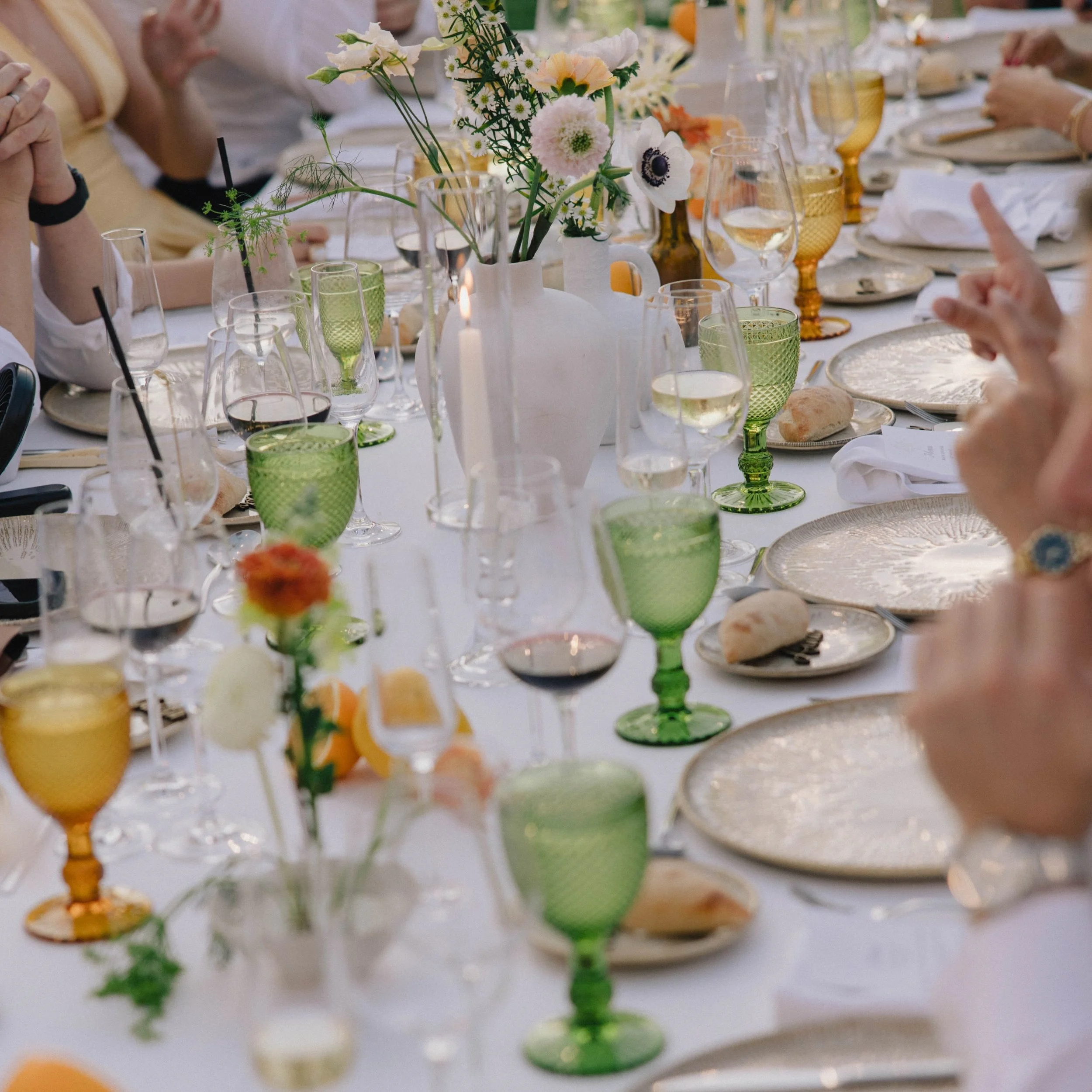 We wanted color, but a single glass shade felt too safe&mdash;so we mixed pressed green and amber.

We kept the base linen crisp white to let the glassware pop, while textured chargers brought in those earthy finca tones to anchor the whole table. 

