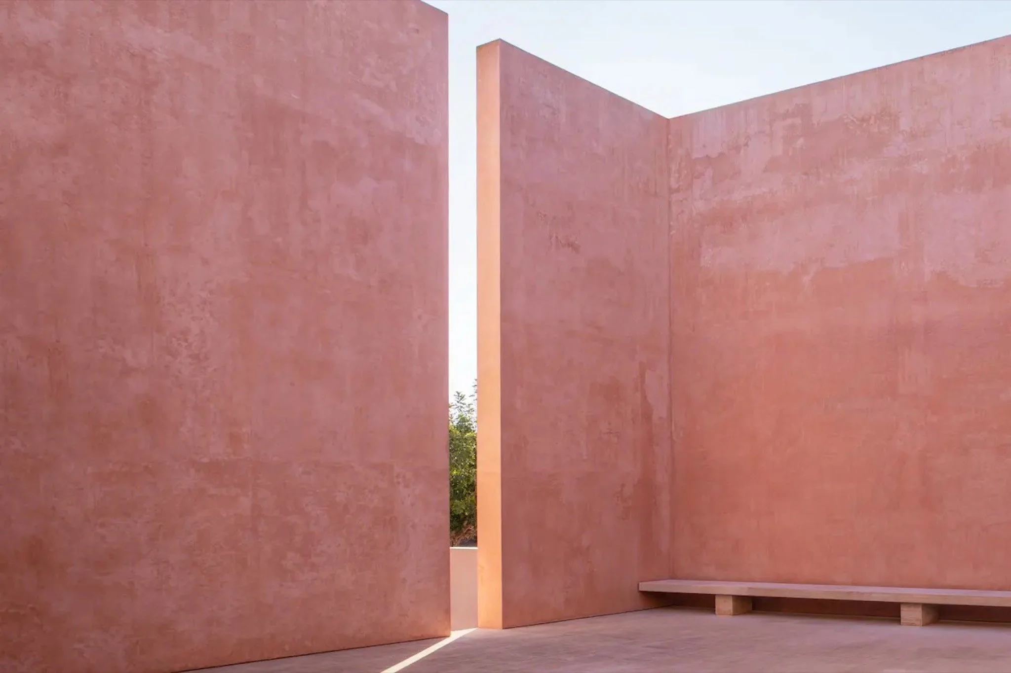 Architectural terracotta pink walls and courtyard design at Neuendorf House luxury wedding venue in Mallorca, Spain.