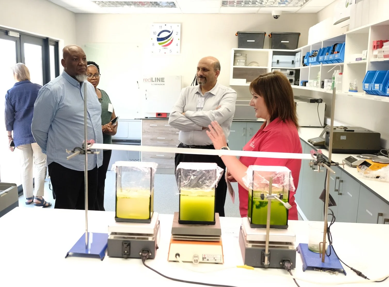  Charles Mokonoto, Nokuthula Mthethwa and Imraan Patel listen as Mariana Erasmus explains the workings in one of the CMBG labs, whilst Judith Sealy has a peek outside. 