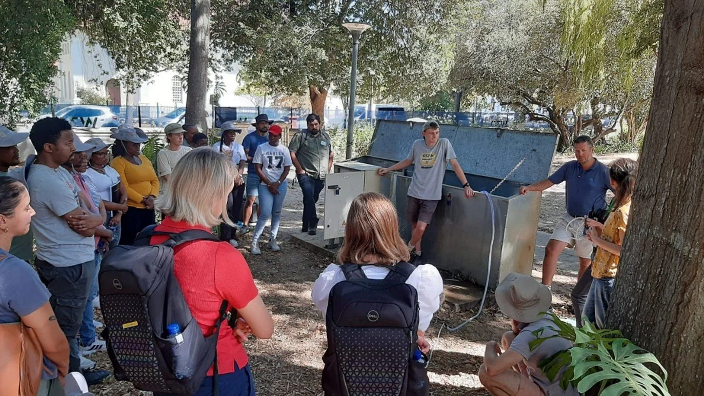  Attendees sampling a borehole on campus for immediate radon measurement, and discussing procedures for trace metals, isotopes and other analytes. 
